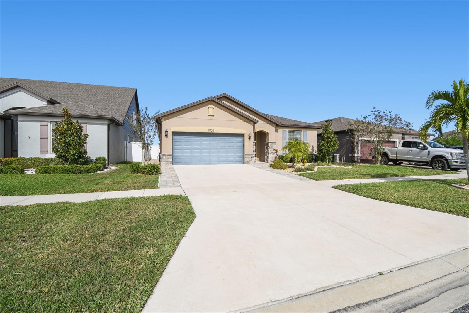 Front of the home with beautiful manicured lawn