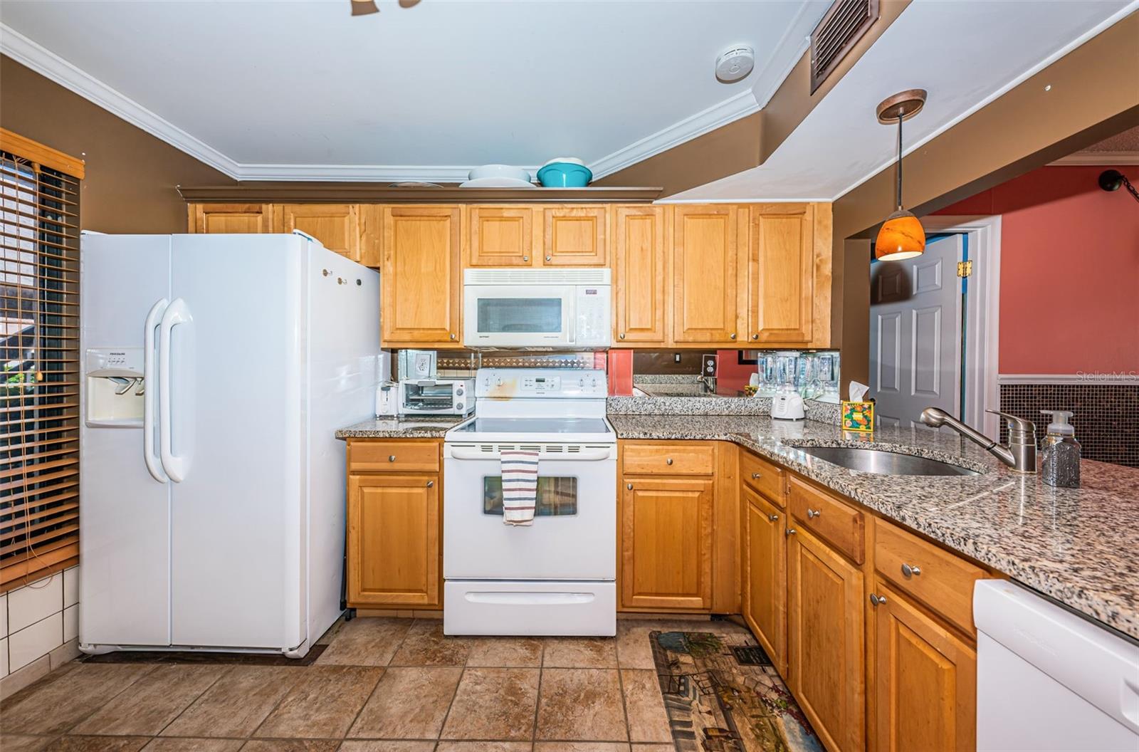 Kitchen with Pretty Cabinetry and  Granite Countertops