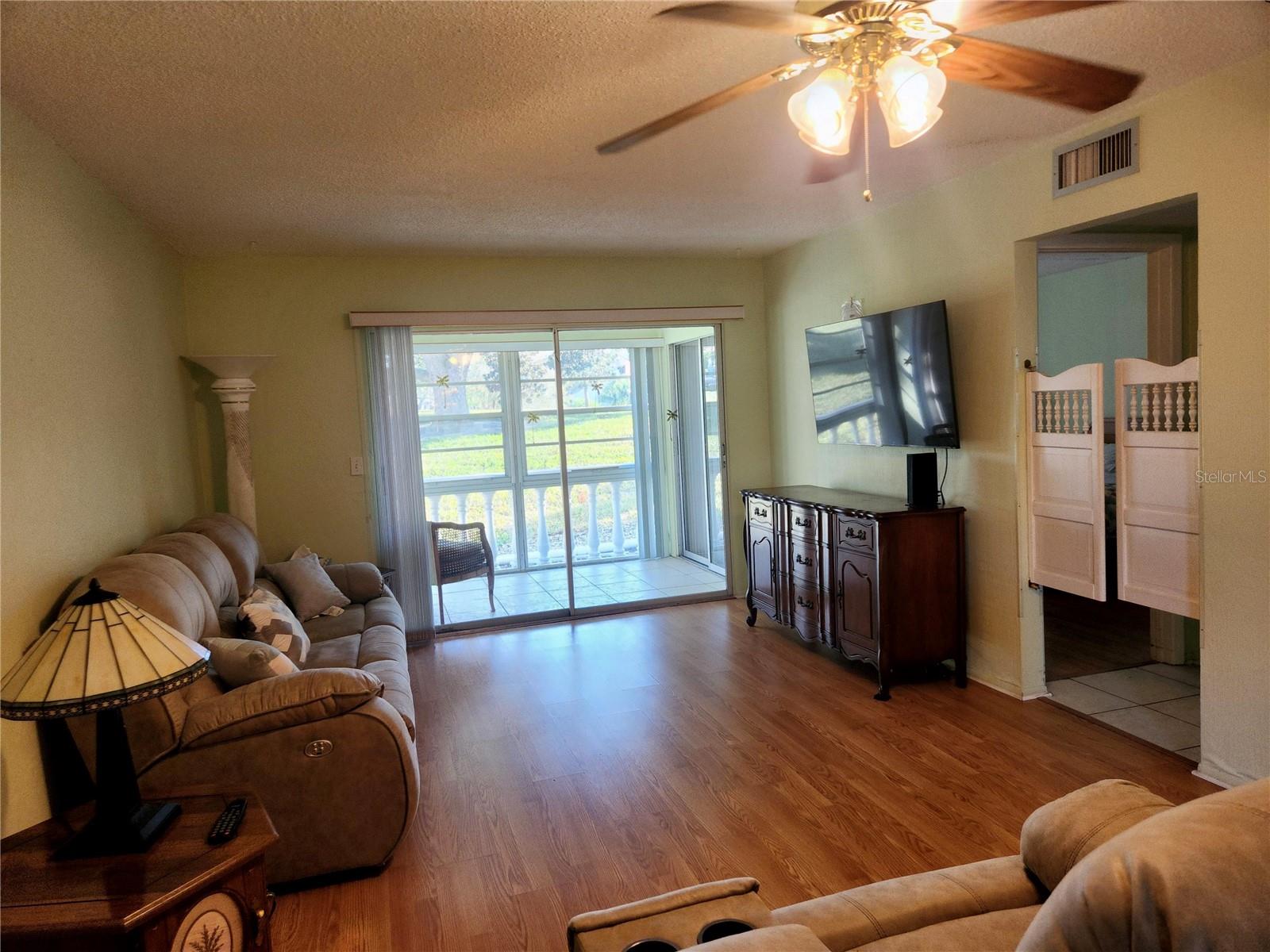 Living Room with Laminate floor and slider to the Lanai.