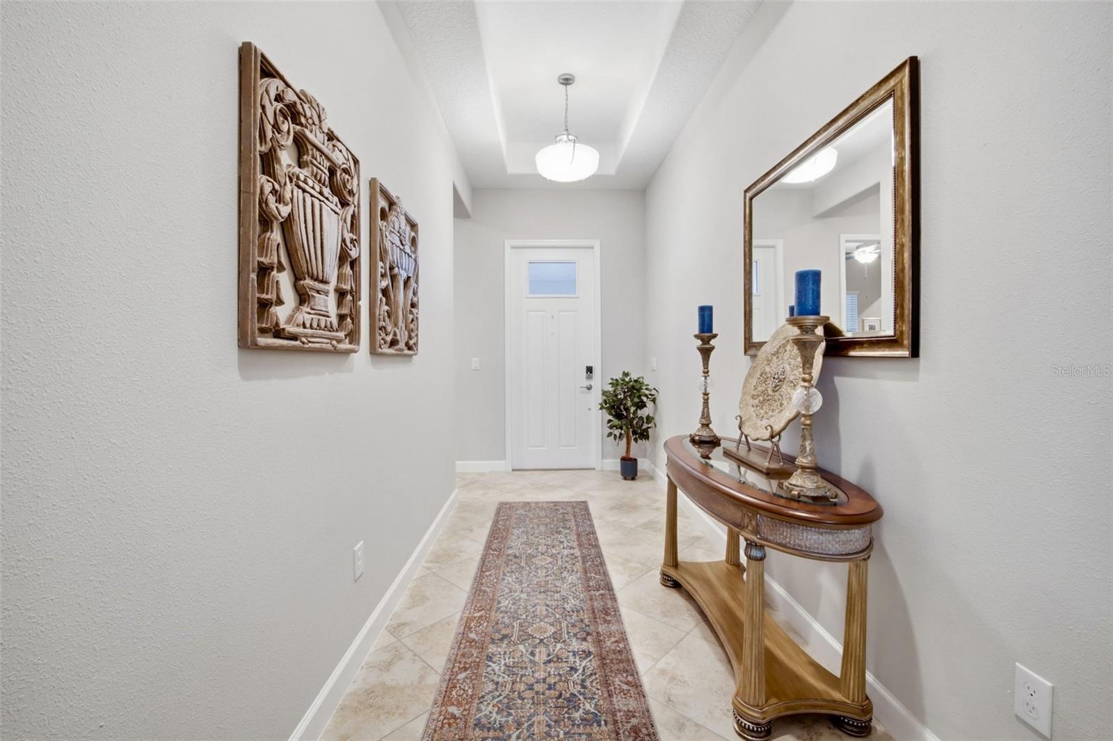 Inviting FOYER boasts tray ceiling entrance
