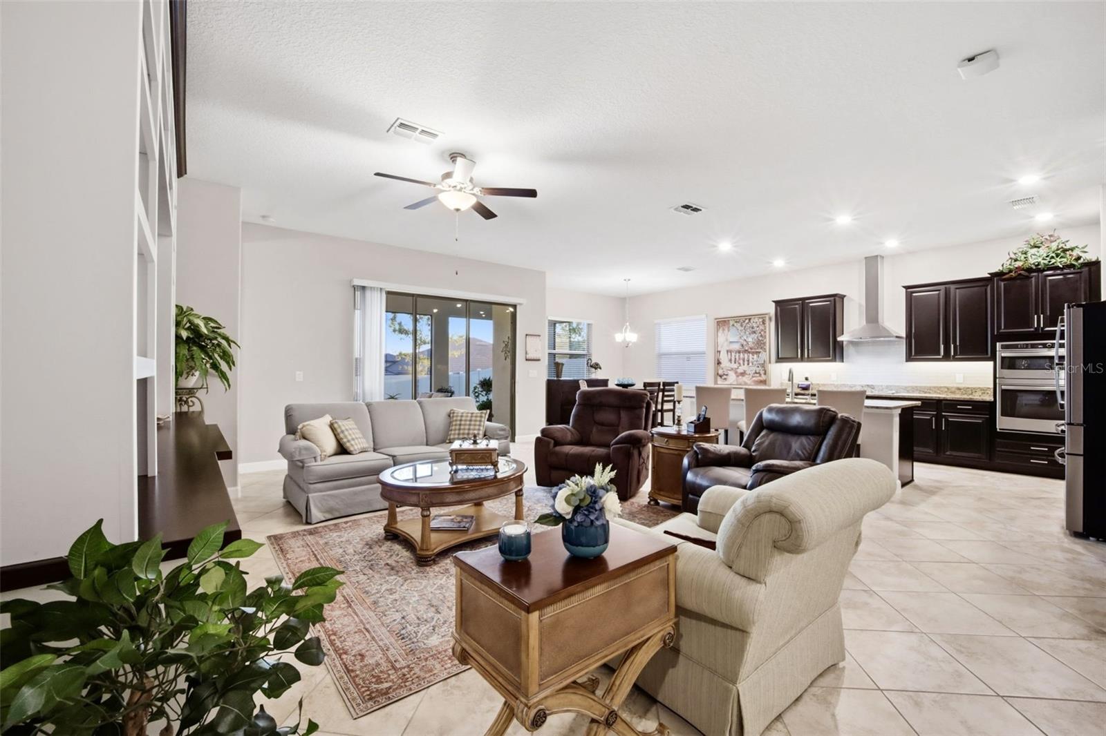 Open to kitchen with sliding glass doors to lanai