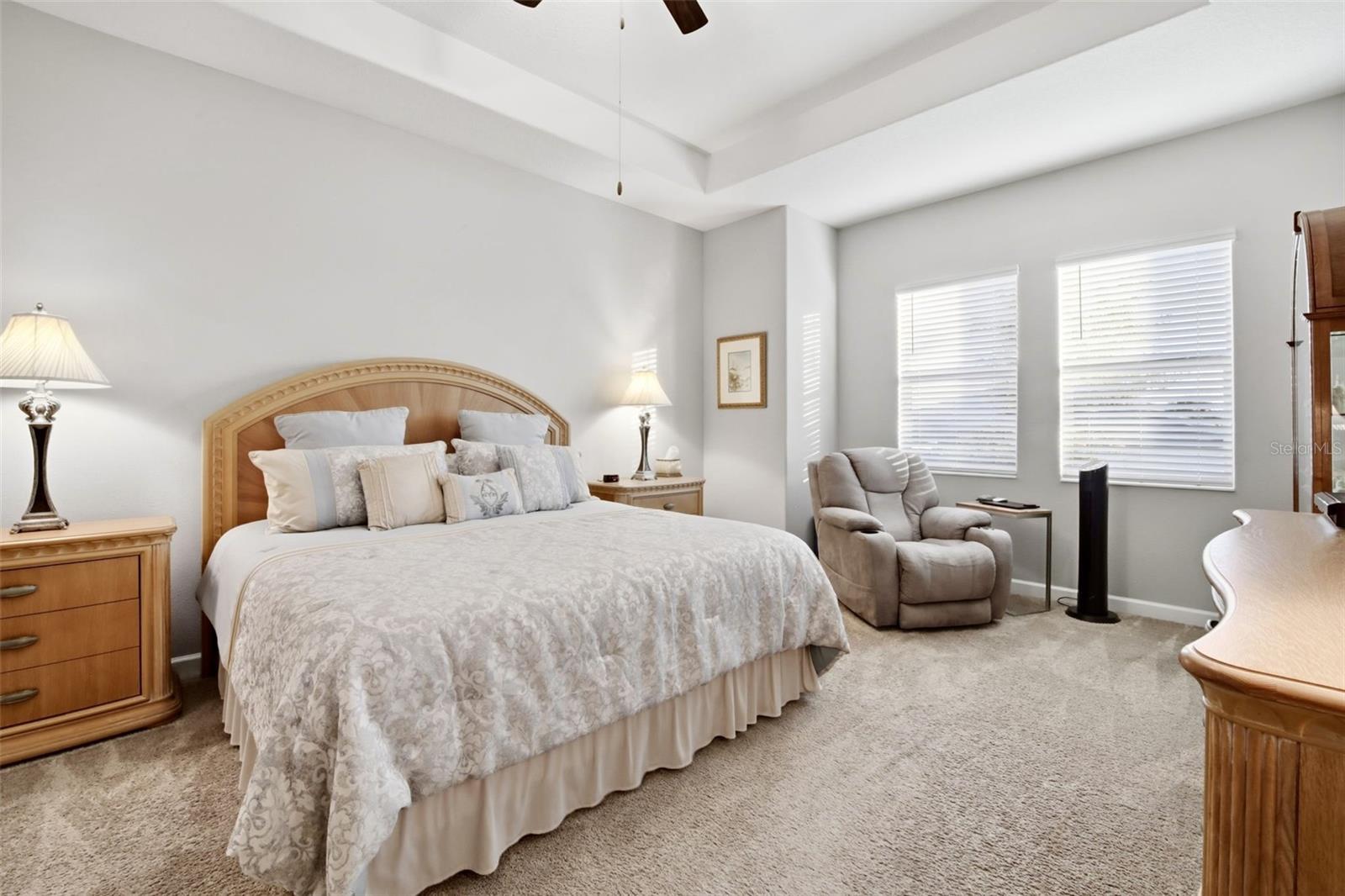 Sitting area in primary bedroom overlooks backyard