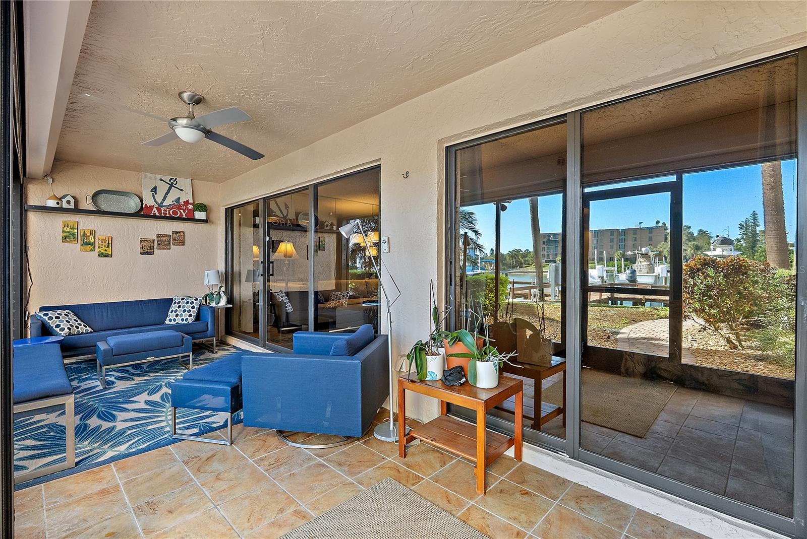 Expansive patio with living area and primary bedroom access. Hurricane shutters on the outer screen.