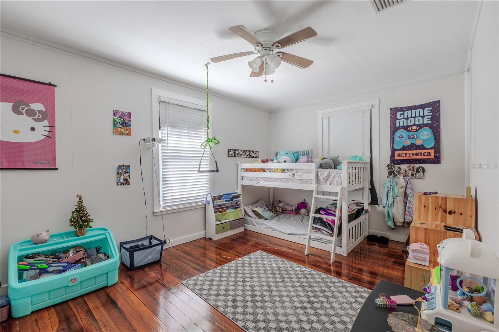 This cheerful second-floor bedroom offers plenty of space for furniture and play, with beautifully maintained wood floors and large windows that bring in abundant natural light. A ceiling fan enhances comfort, and the neutral wall color makes it easy to personalize. This versatile room is perfect for a child’s bedroom, guest room, or creative space.