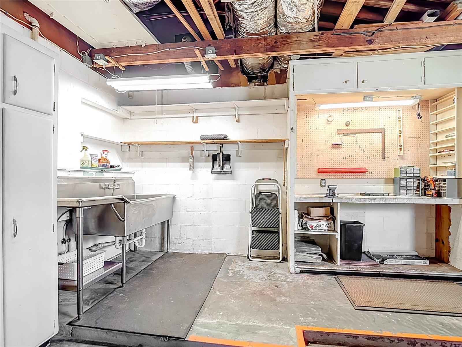 Garage with Workbench, Sink Area, and Storage