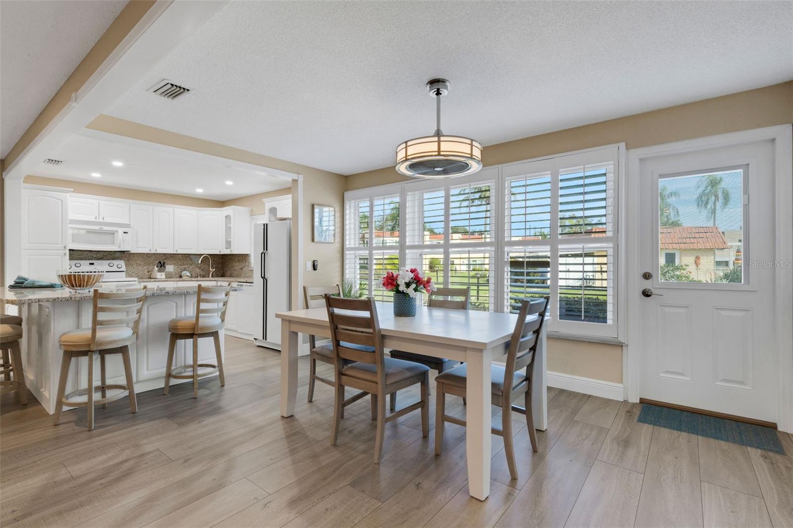 Dining Area With Pedestrian Door at Right Opens to the Walkway to Pool and Clubhouse