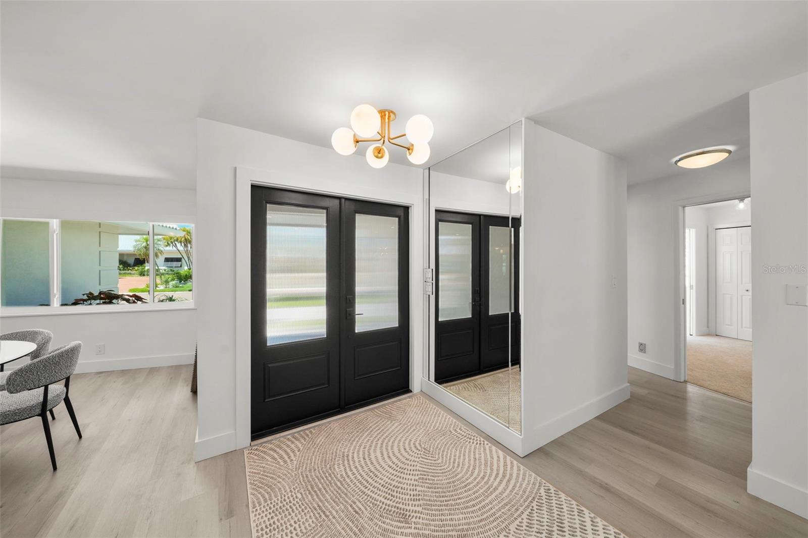 A custom made double door entrance designed for natural light and a welcoming first impression.