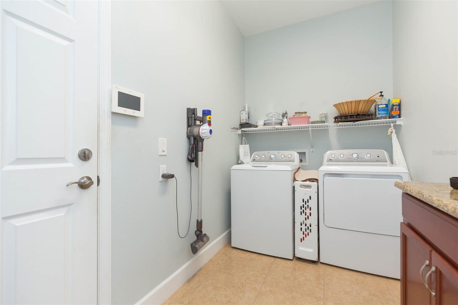 Laundry room with entrance to garage