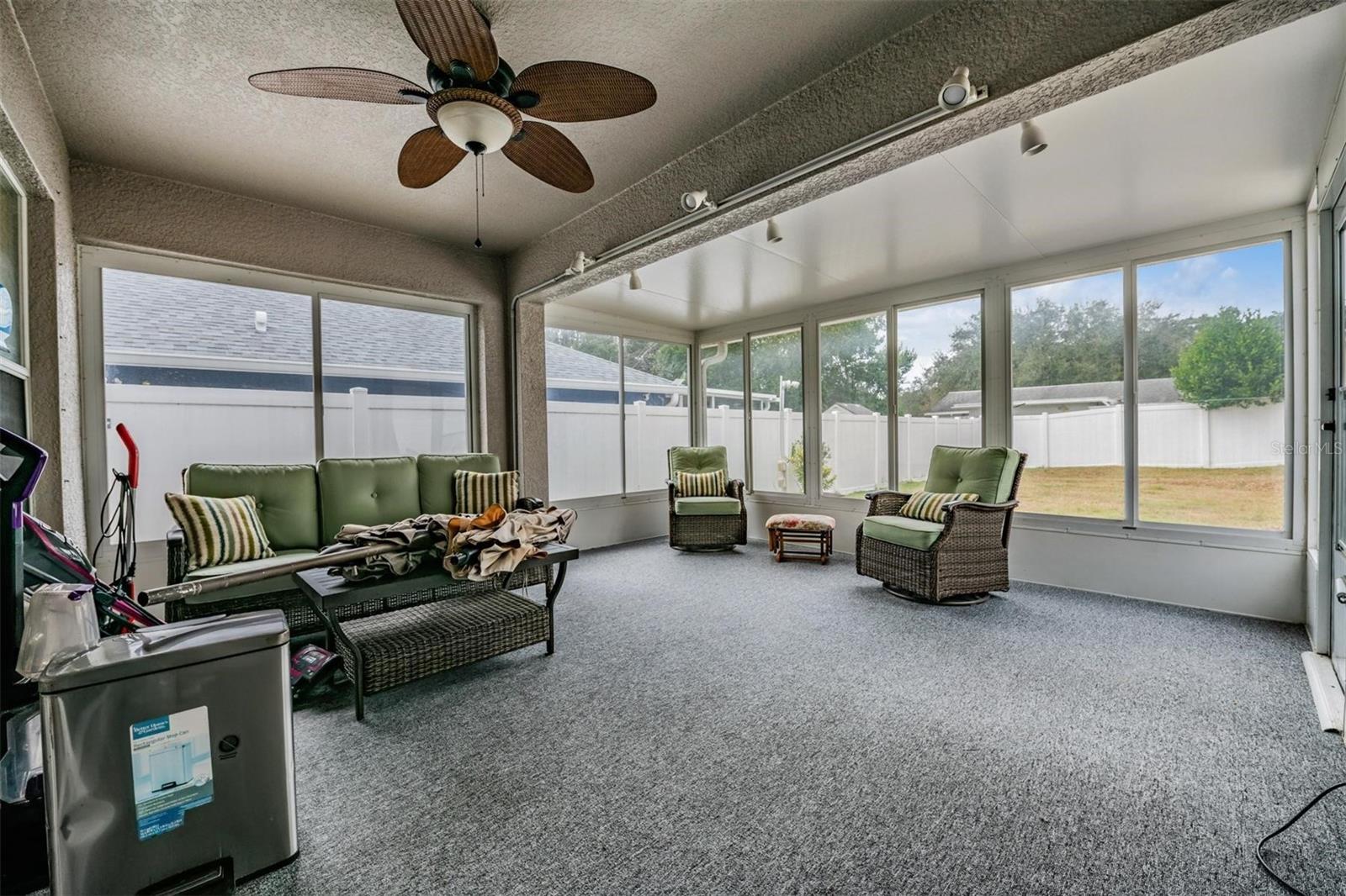 Make memorable family memories in this enormous enclosed patio with fan, windows and an exit door to the back yard.