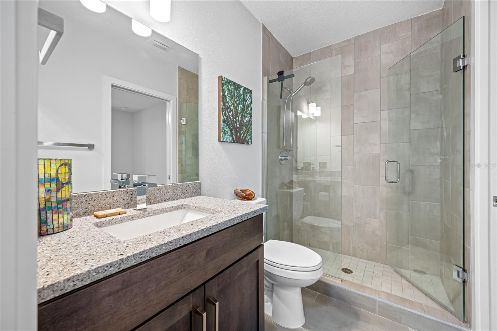 Full bathroom with walk-in shower. First Floor - 3rd Bedroom with en-suite full bathroom & walk-in closet.