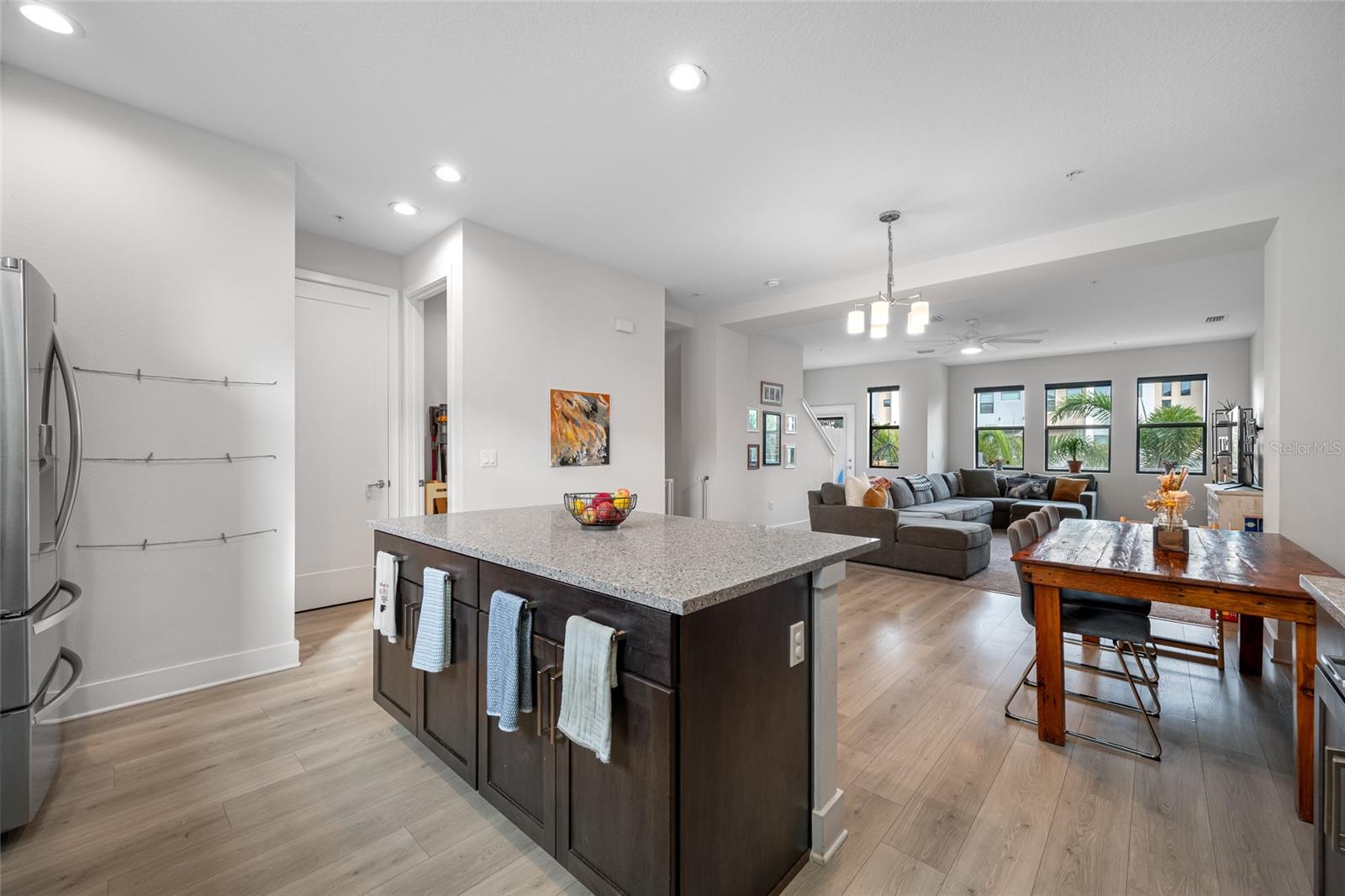 Gourmet kitchen with quartz countertops, Open to the dinning and living room. 10 ft ceilings and oversized windows let in lots of natural light. Second Floor