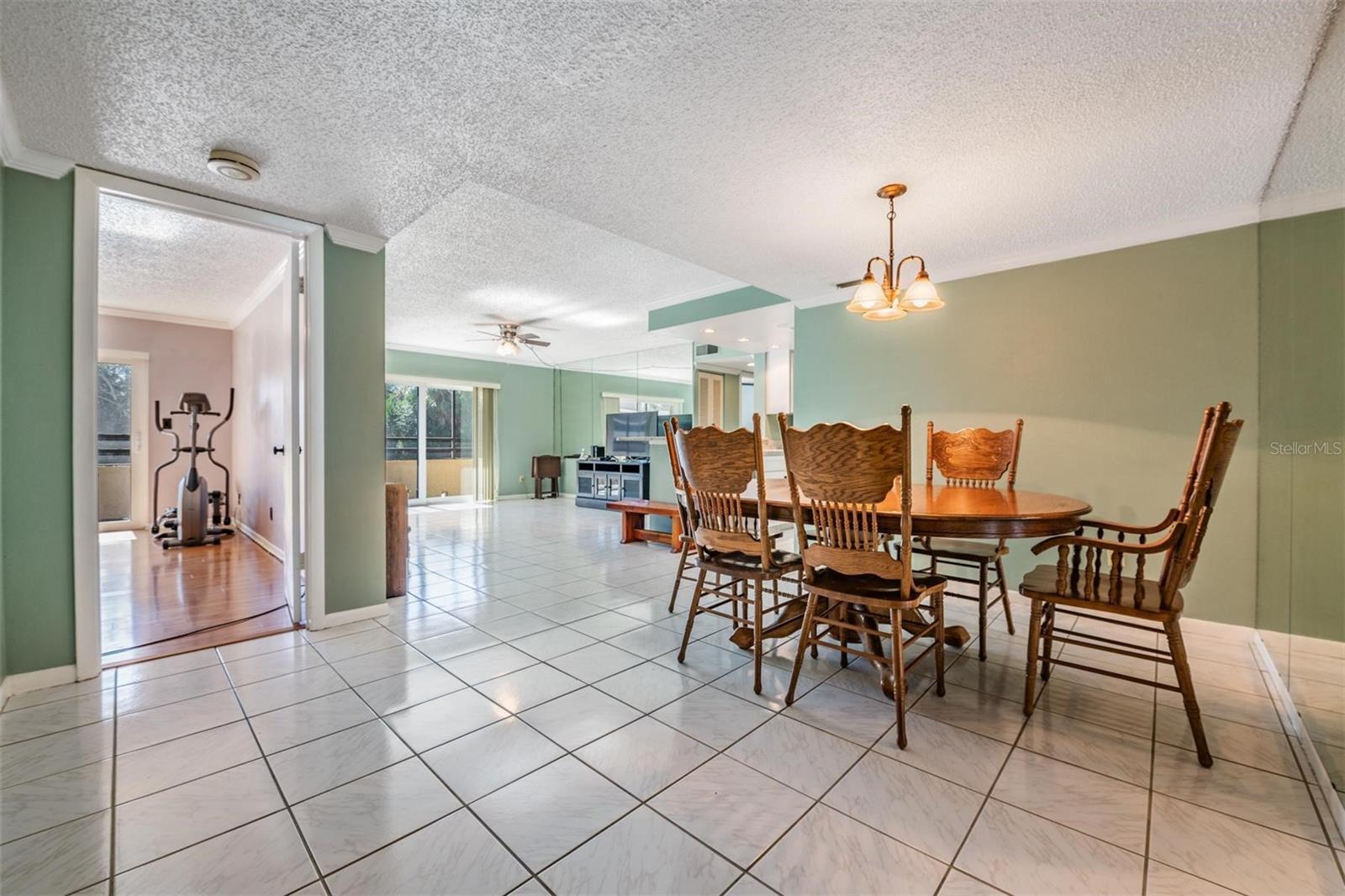 View from front door of primary suite entrance, dining area and great room