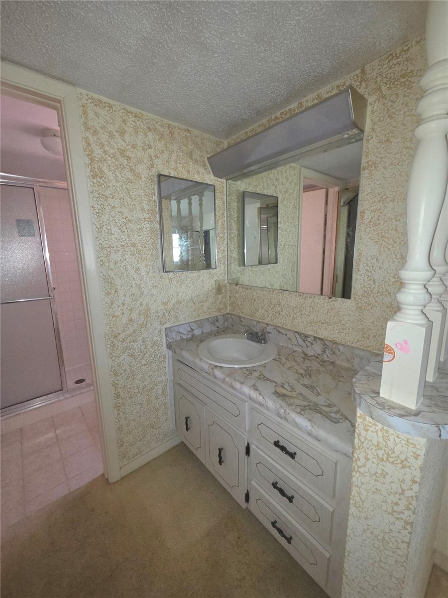 Sink is across from the large walki in closet