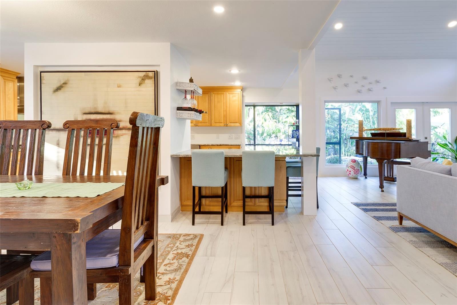 From the dining room, the entertainment extends to the wrap-around breakfast bar with stunning Brazilian Quartzite with actual Garnets nestled within the stone.