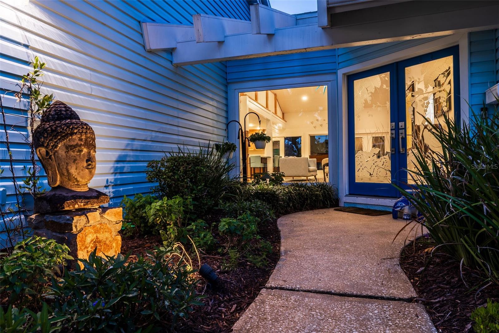 Backlit areas for outdoor art, a peaceful water feature and natural, Florida-native plants line the path toward your oasis.