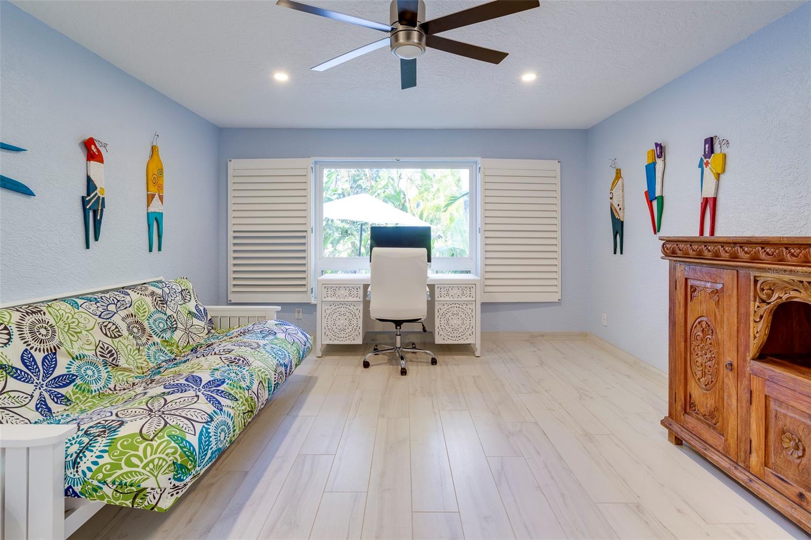 Downstairs, bedroom 2 features beautiful views of the backyard oasis.