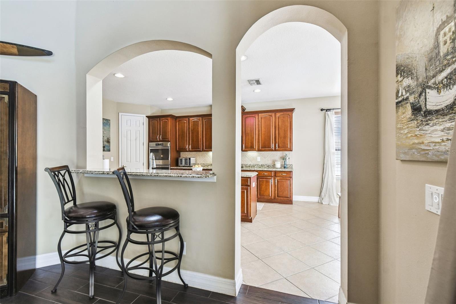 Bar stool seating adjacent to kitechen