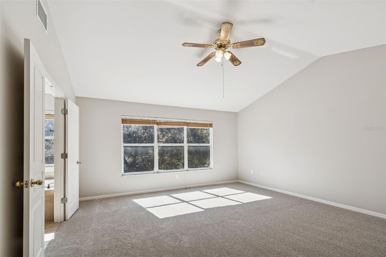 Spacious primary bedroom with high ceilings