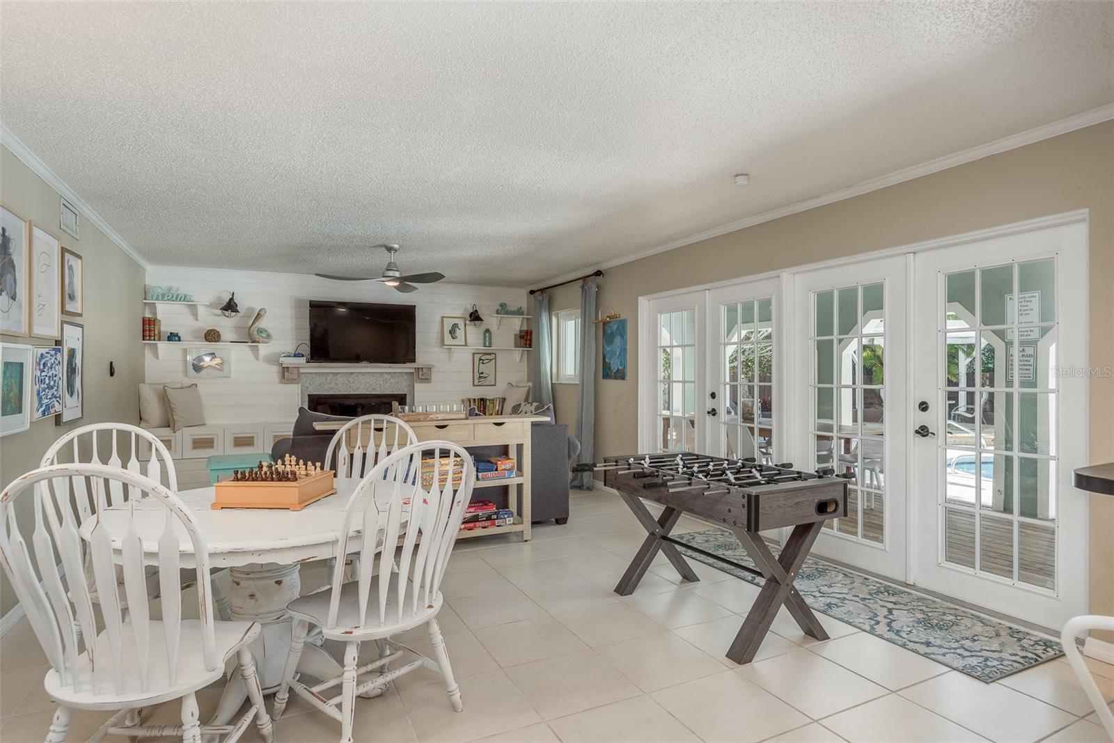 Family room with double french doors that lead to deck and pool