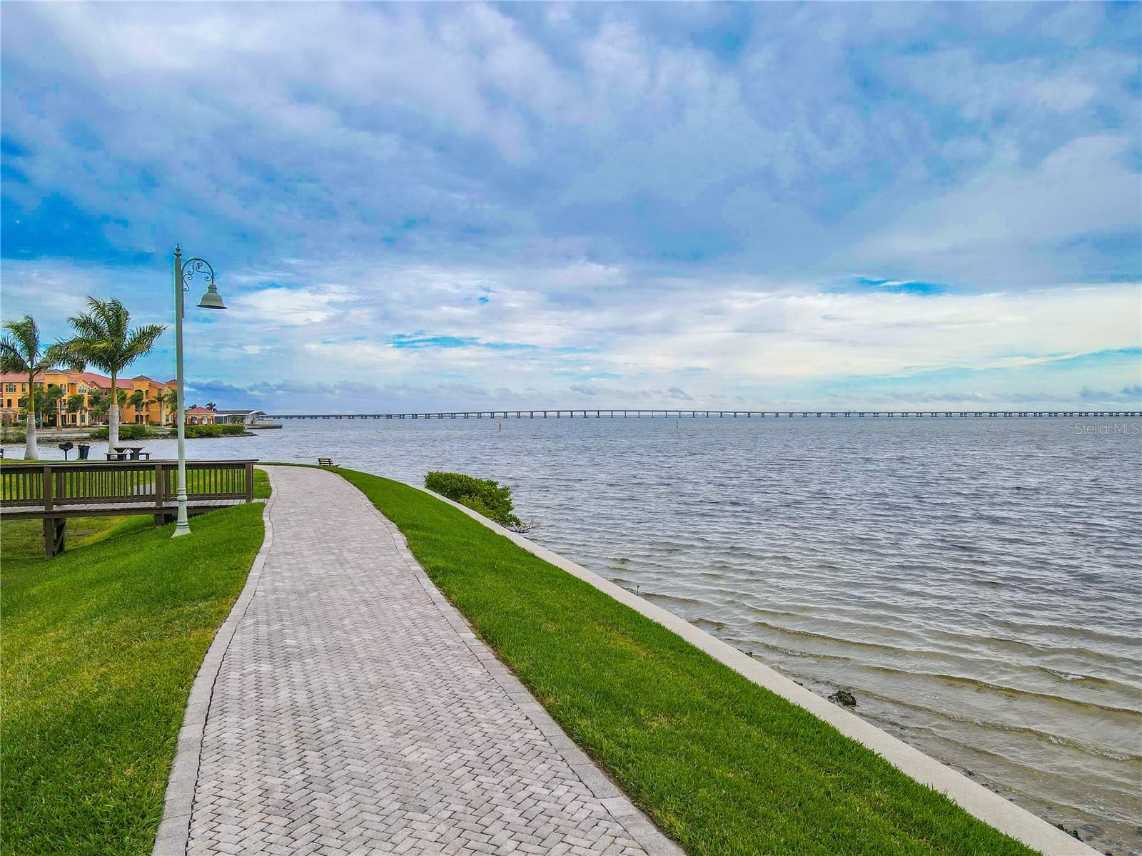 Scenic waterfront promenade with a paver walking path along Old Tampa Bay, perfect for sunrise strolls, biking, and enjoying expansive water views.