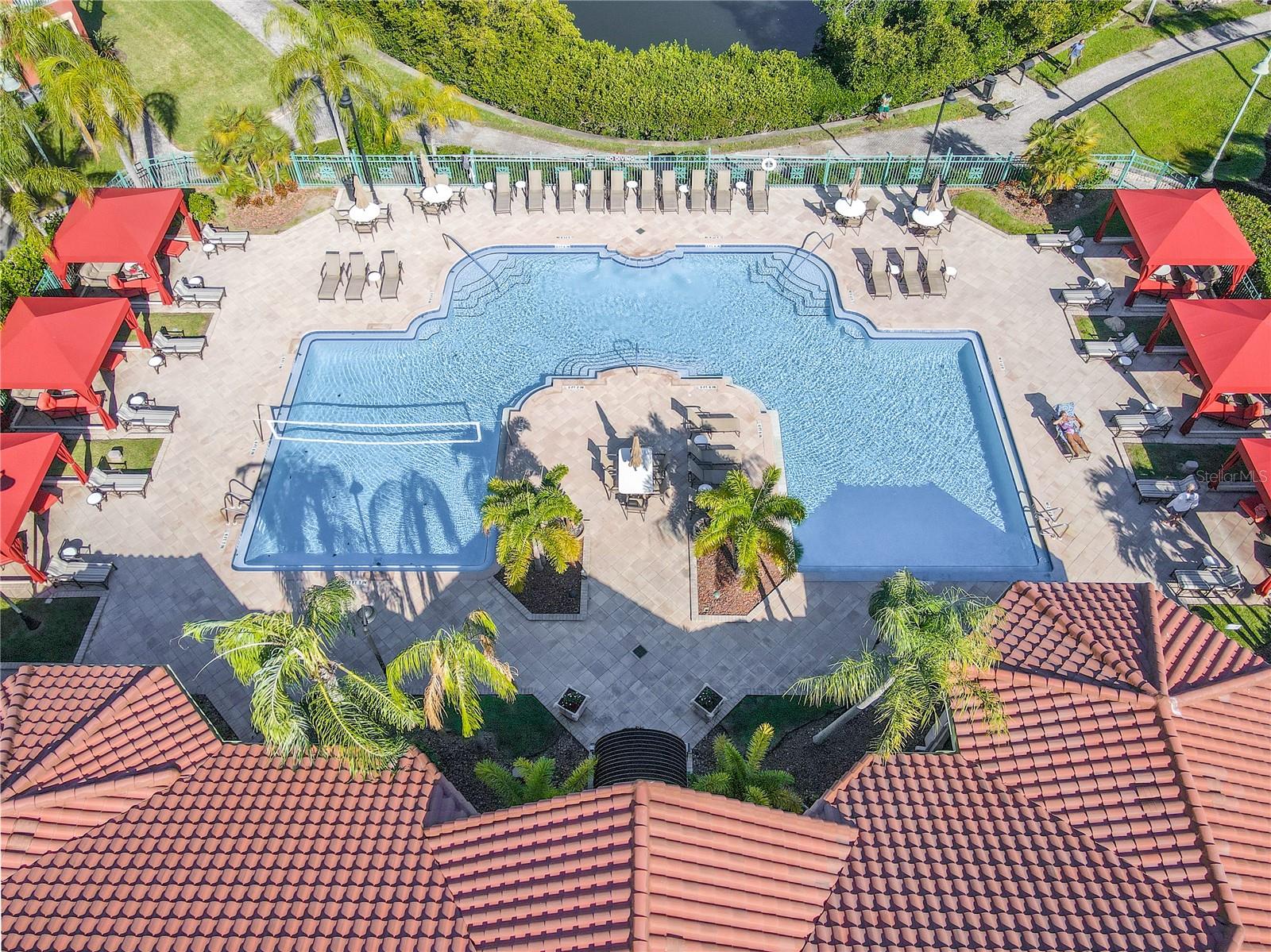 Resort-style heated clubhouse pool and spa with a spacious sundeck, lounge seating, and private rentable cabanas—perfect for relaxing, entertaining, and soaking up the Florida sunshine.