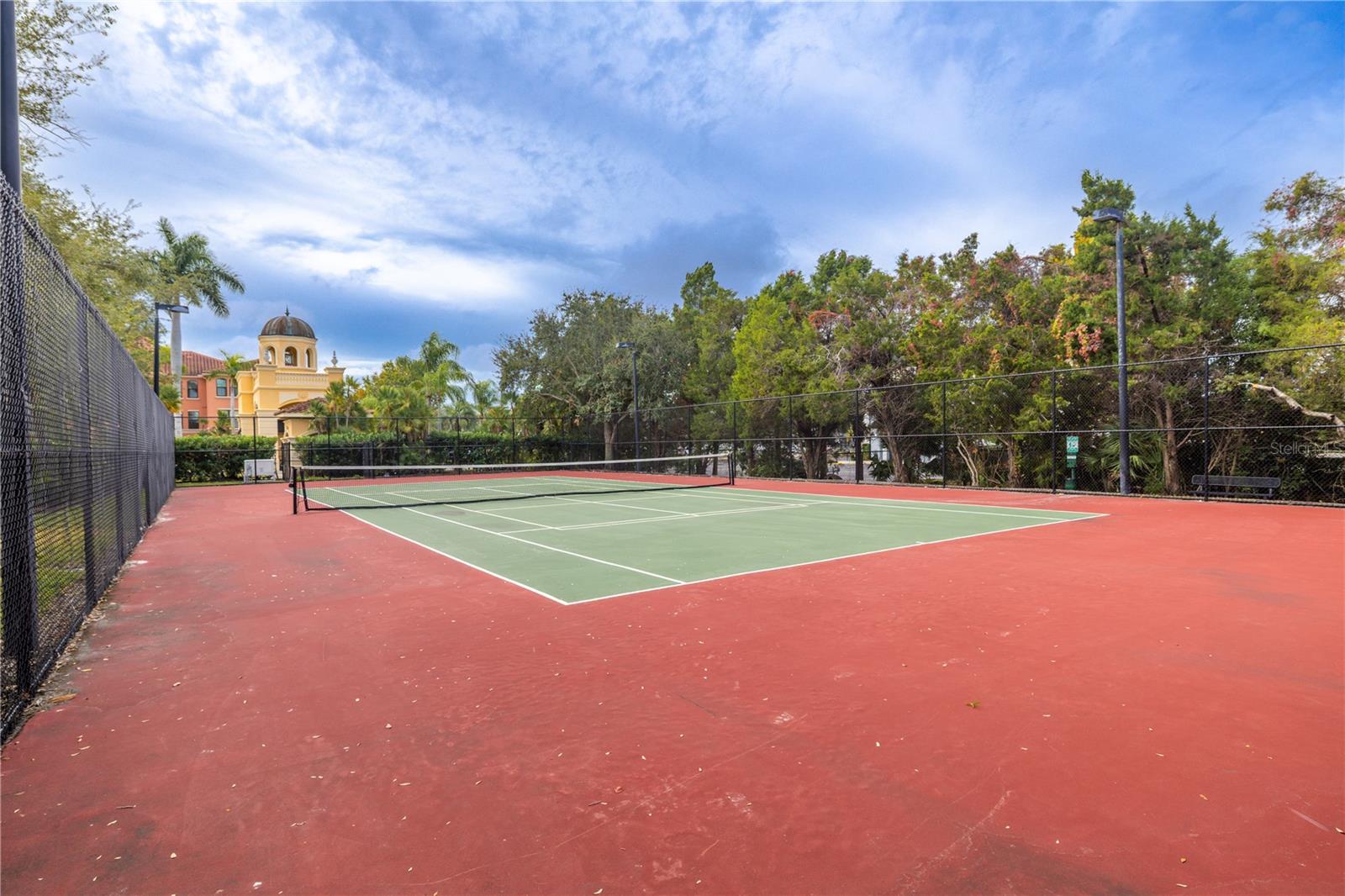Community tennis courts set in a beautifully maintained, palm-lined setting—perfect for active living and enjoying the resort-style amenities.