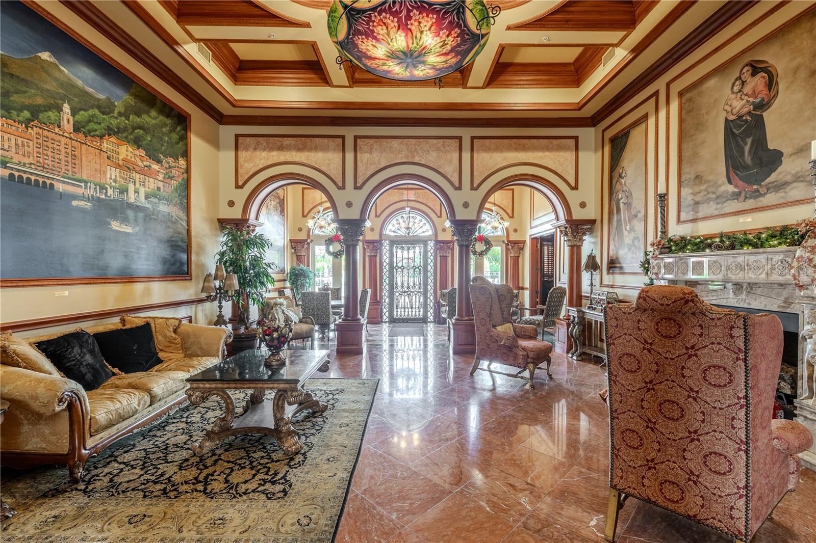 Grand clubhouse lounge with soaring coffered ceilings, dramatic murals and arched columns, gleaming marble floors, and an elegant fireplace seating area that creates a truly resort-style welcome.