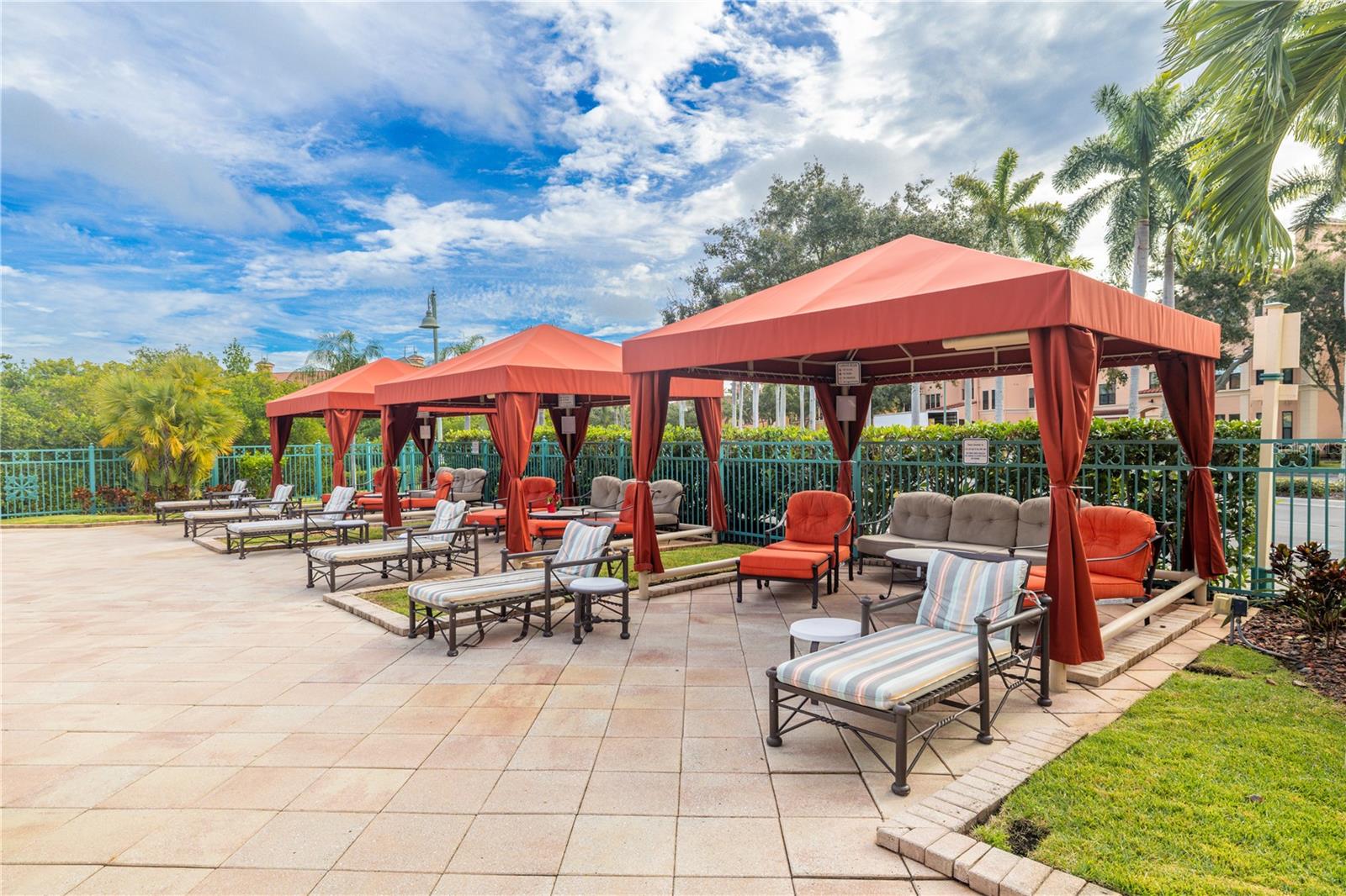 Private poolside cabanas with comfortable lounge seating, perfect for relaxing in the shade and enjoying a true resort-style community atmosphere.