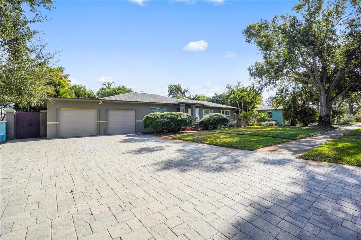 2 car garage with large pavered parking area