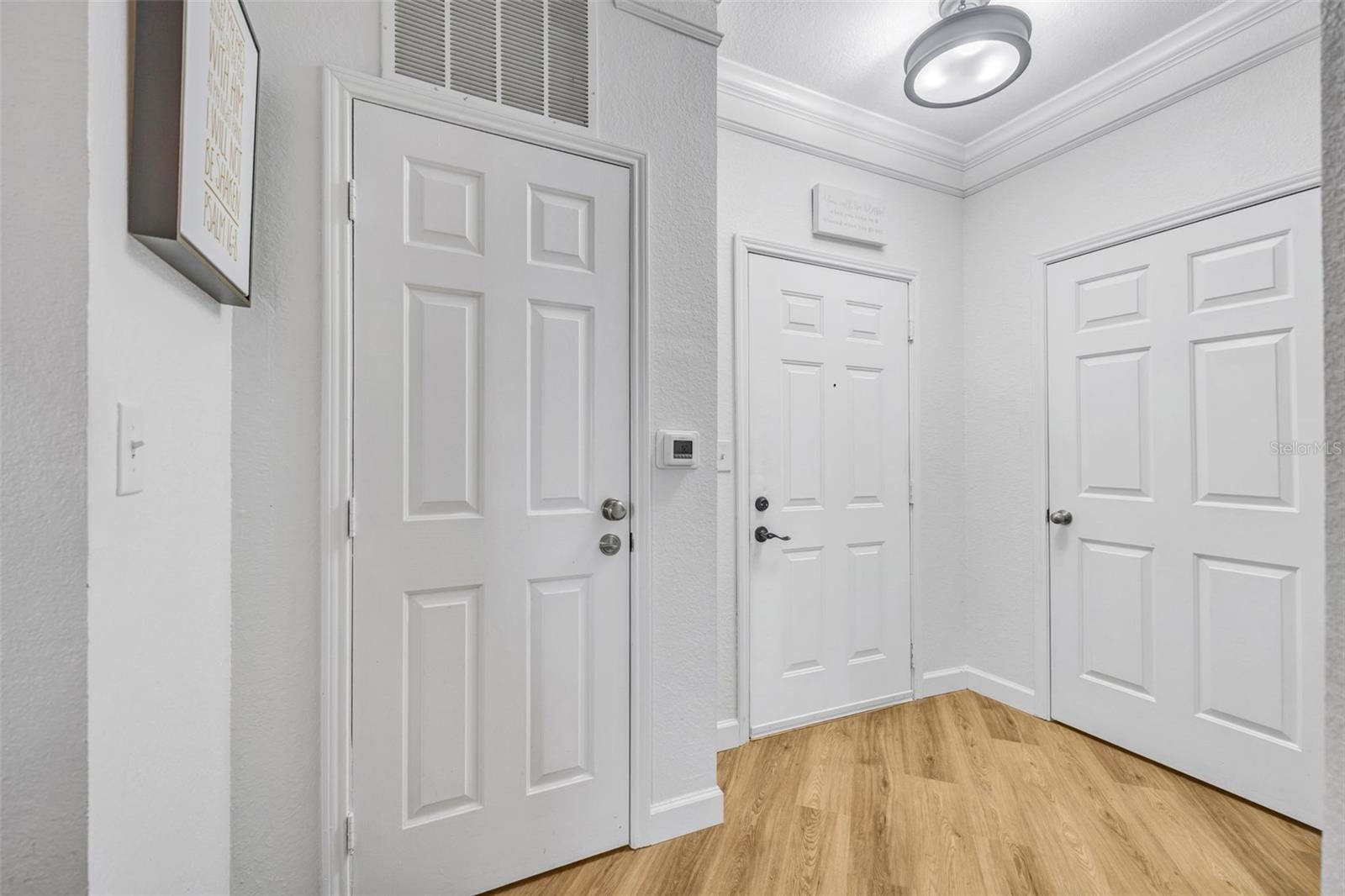 Front door (middle) coat closet to the right, pantry to the left