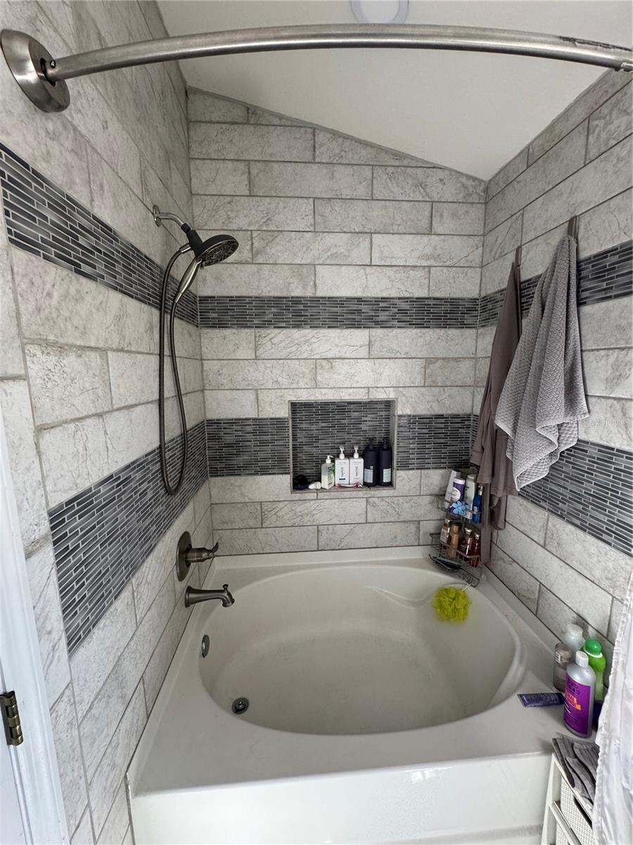 Custom tiles with enormous garden tub for soaking in peace