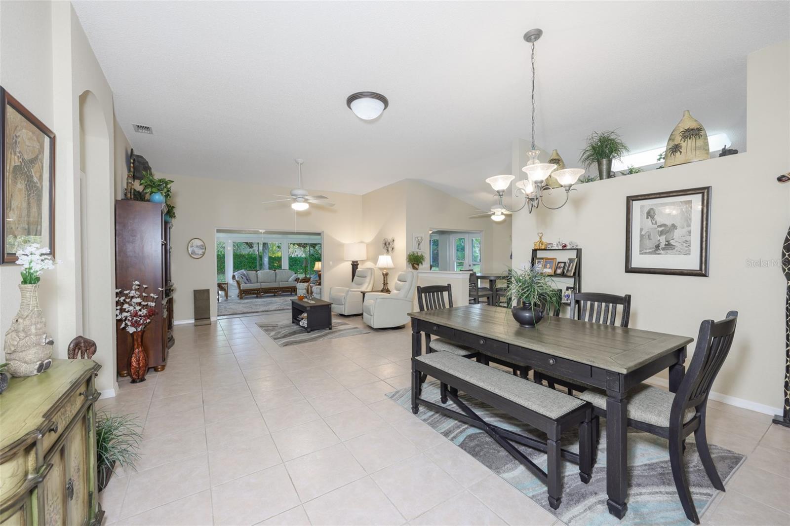 As you enter the home, you see the large open space of the combined dining area and living room and you can't help notice the stunning glassed in lanai which is under air and heat.