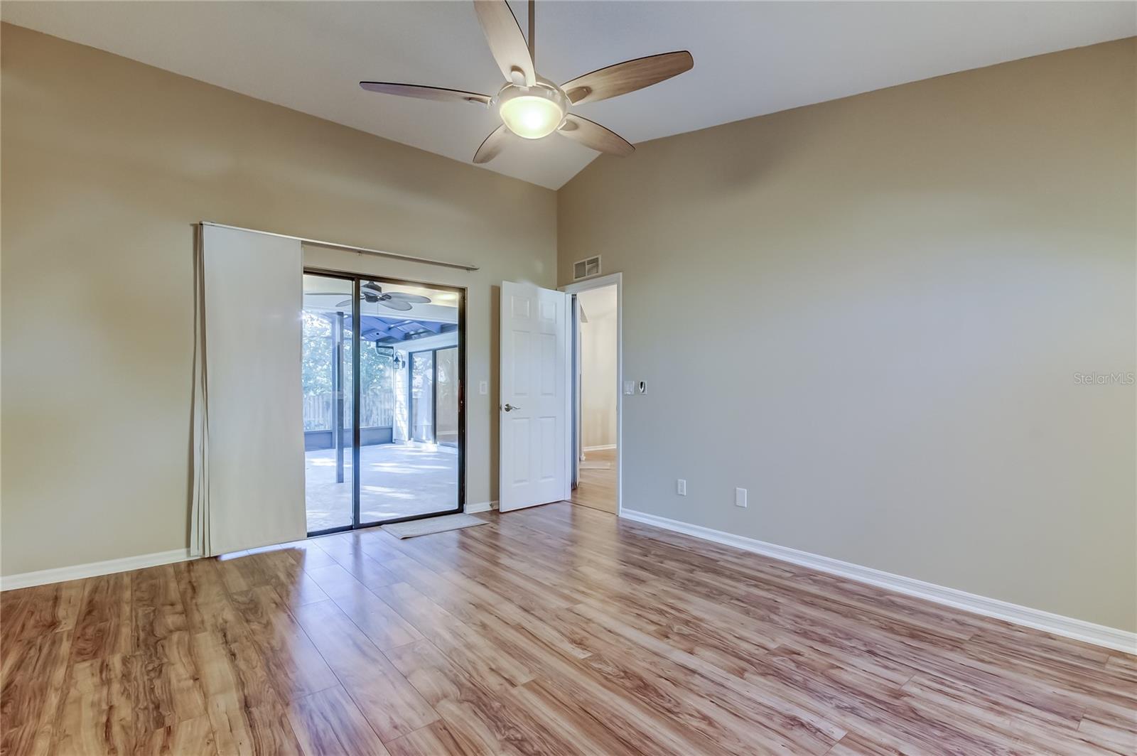28. Primary Bedroom (12.7 ft x 15 ft) Offers Sliders to Lanai & Split Floor Plan Privacy!