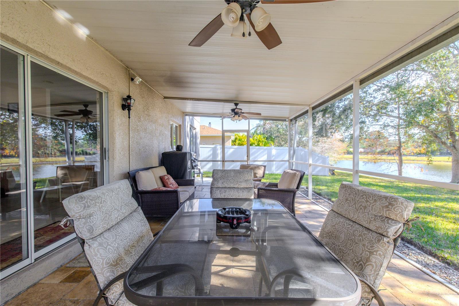 Relax or entertain on the screened lanai with ceiling fans, ample seating and dining space, and serene pond views just beyond the backyard.