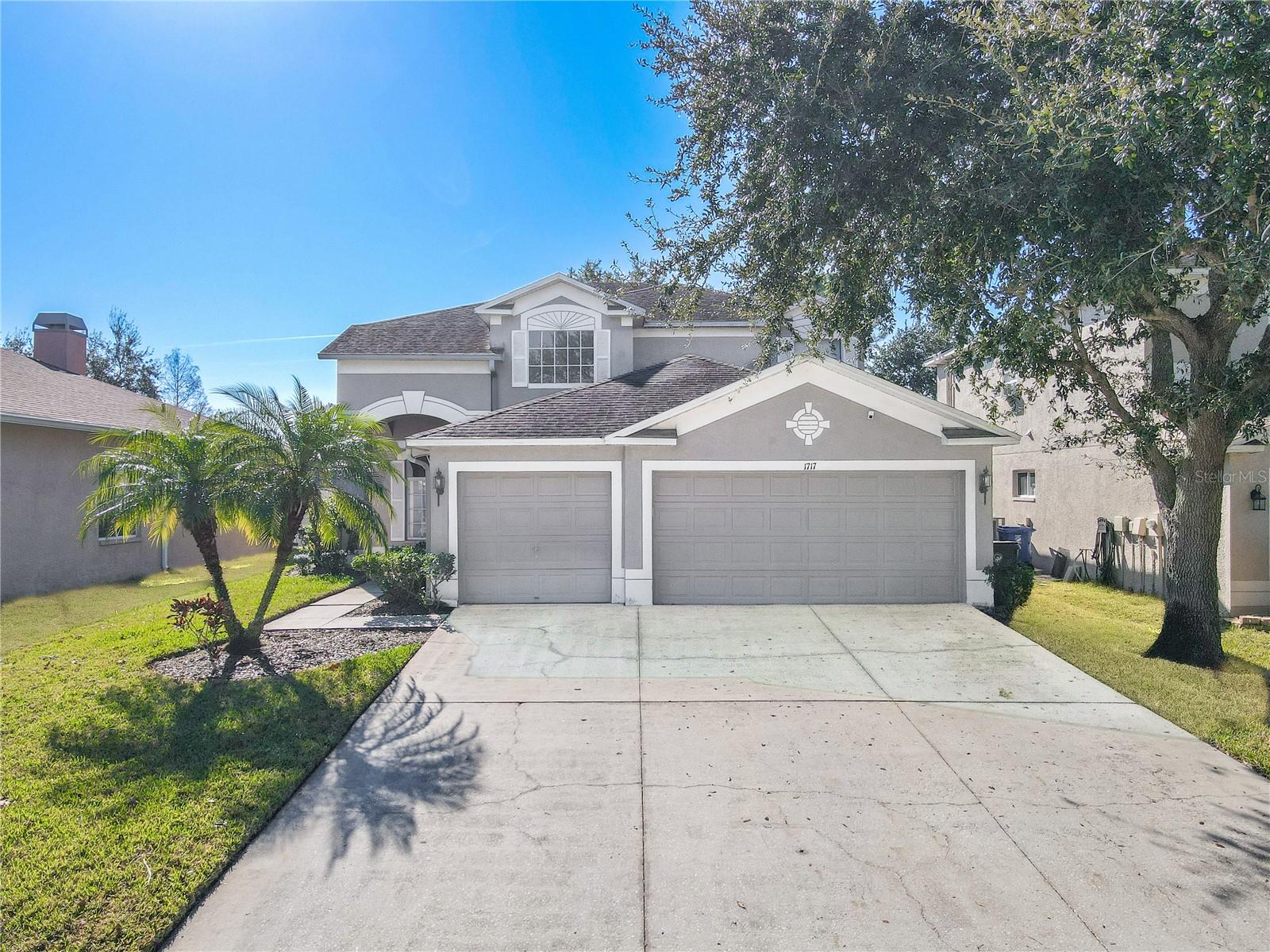 Inviting two-story 4 bedroom/3 bath home with a spacious multi-car garage, wide driveway, and charming curb appeal, enhanced by mature shade trees and easy-care landscaping.