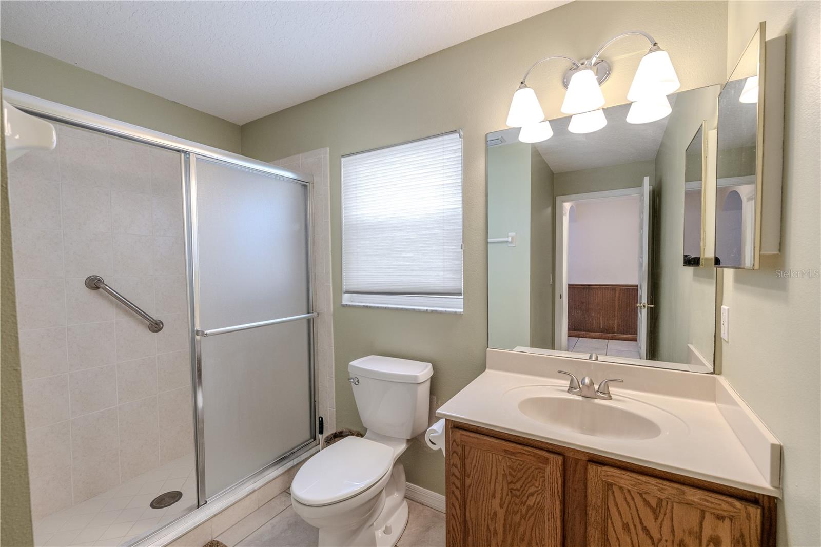 Second full bathroom features a spacious walk-in shower, large vanity with ample counter space, and bright lighting for a clean, refreshed feel.