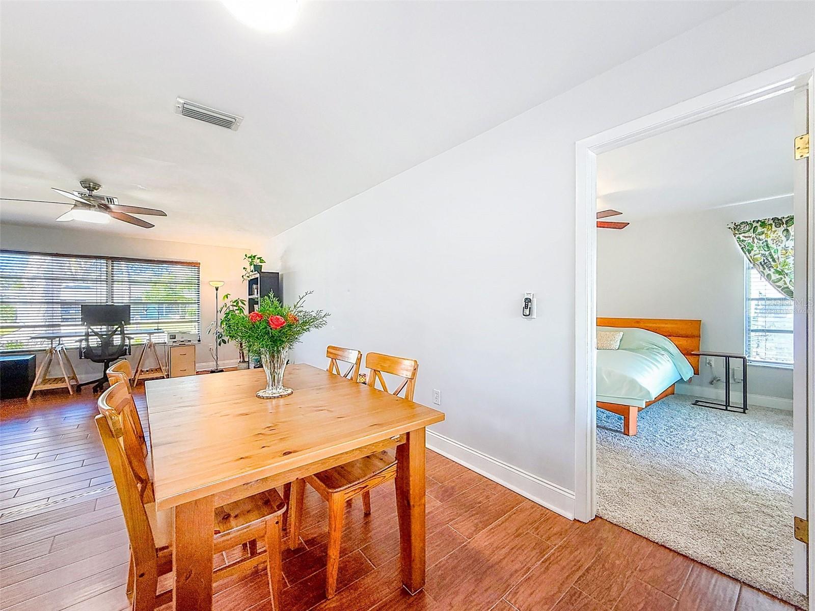 (Virtually Staged Primary Bedroom) | Dining room to living room