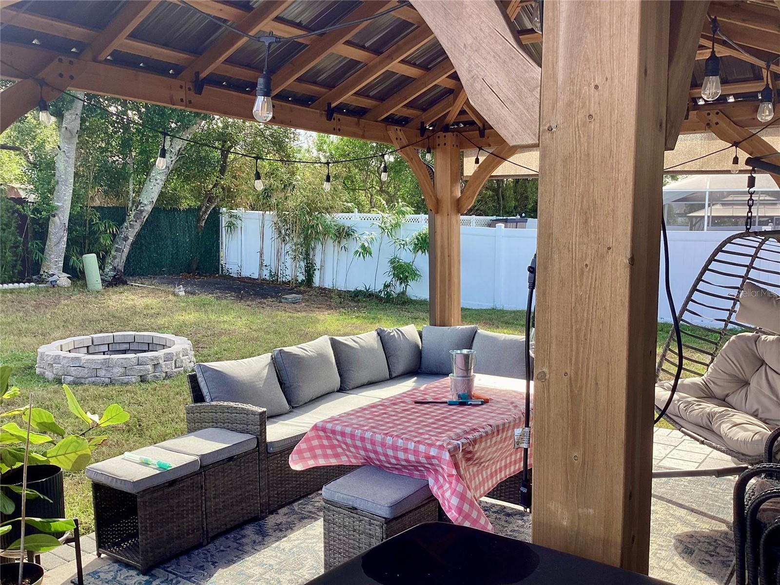 Patio partially covered with hard top gazebo.