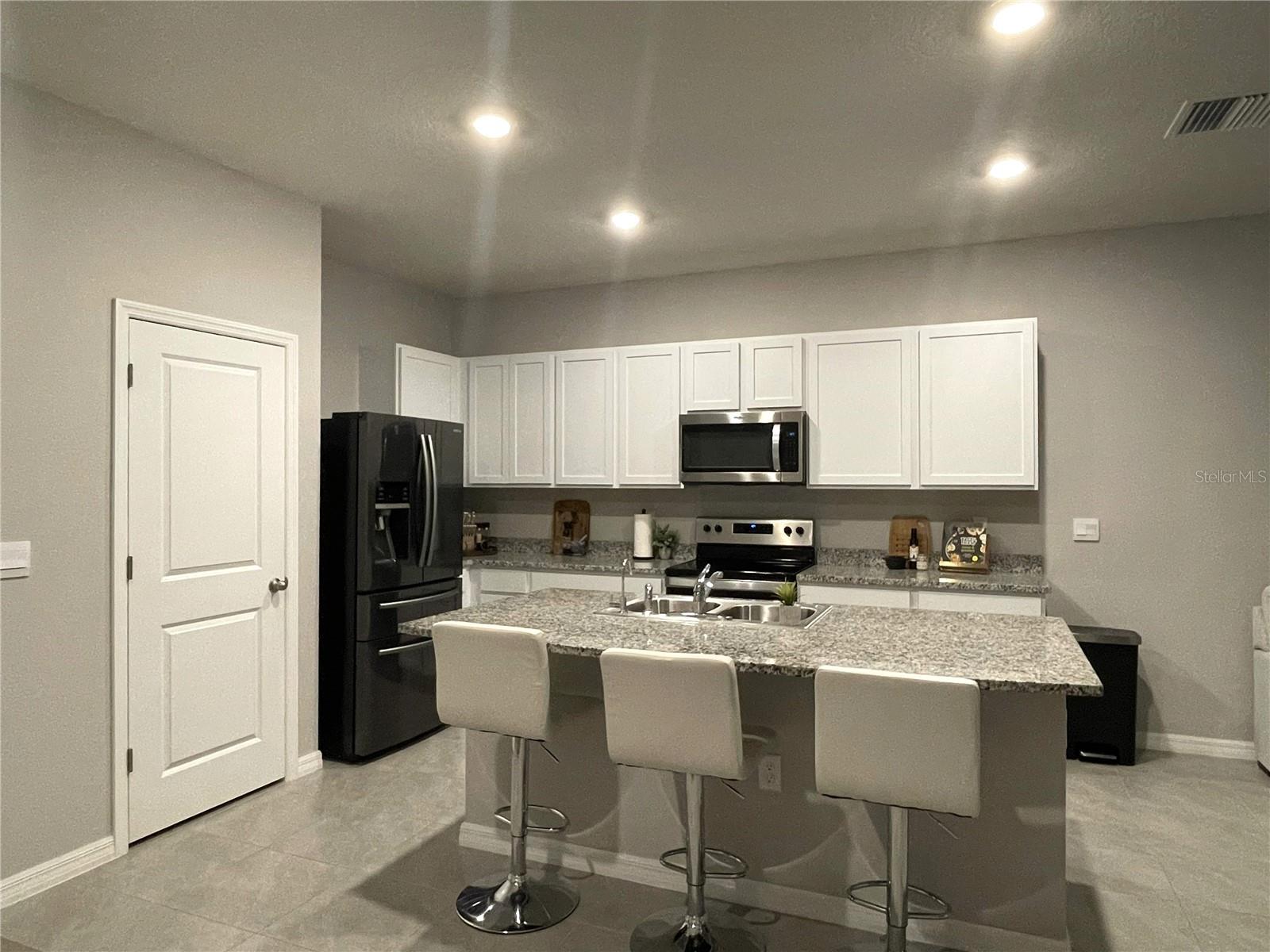 Walk-in pantry next to refrigerator