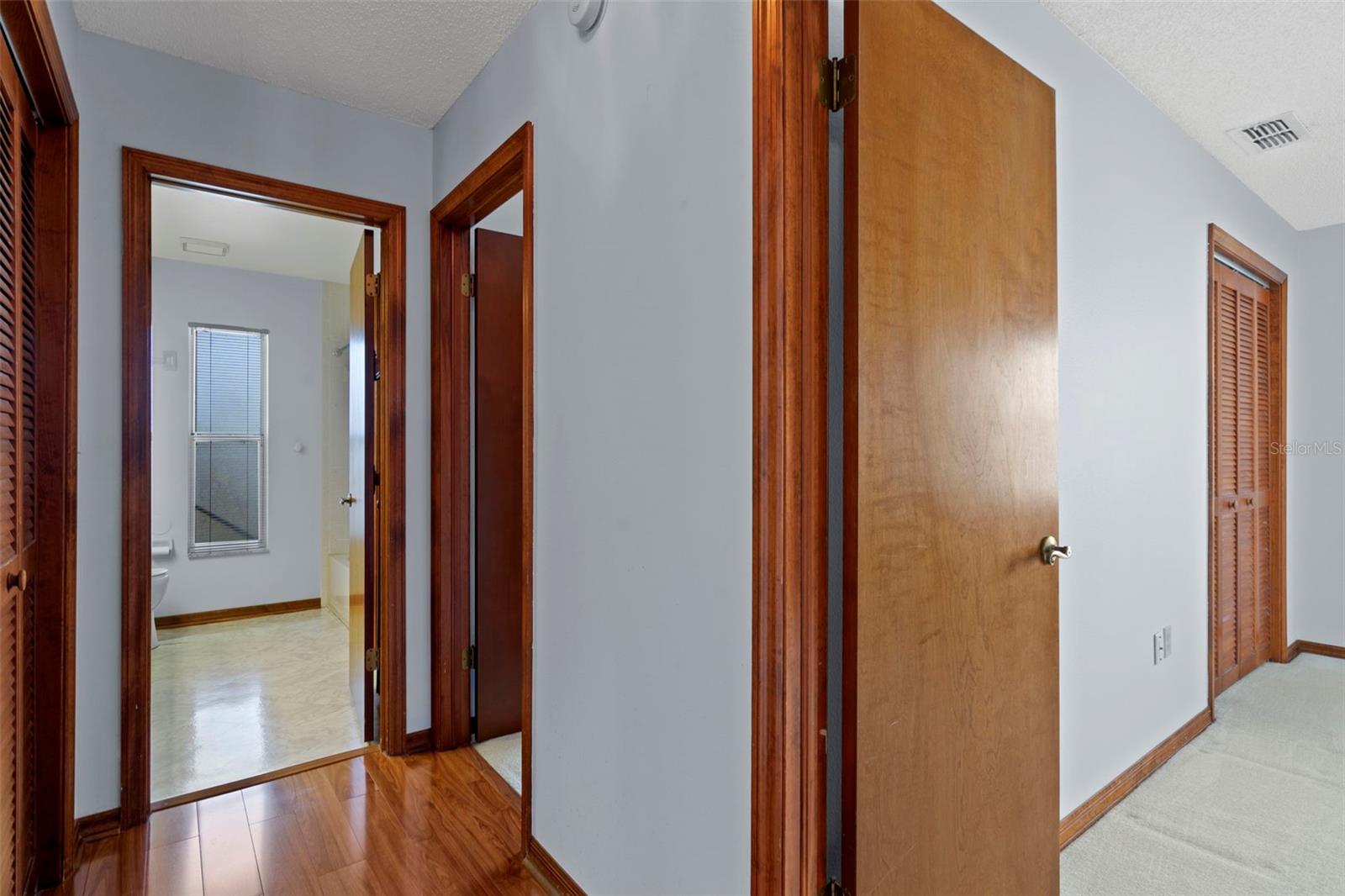 Hallway to second bath and second and third bedroom