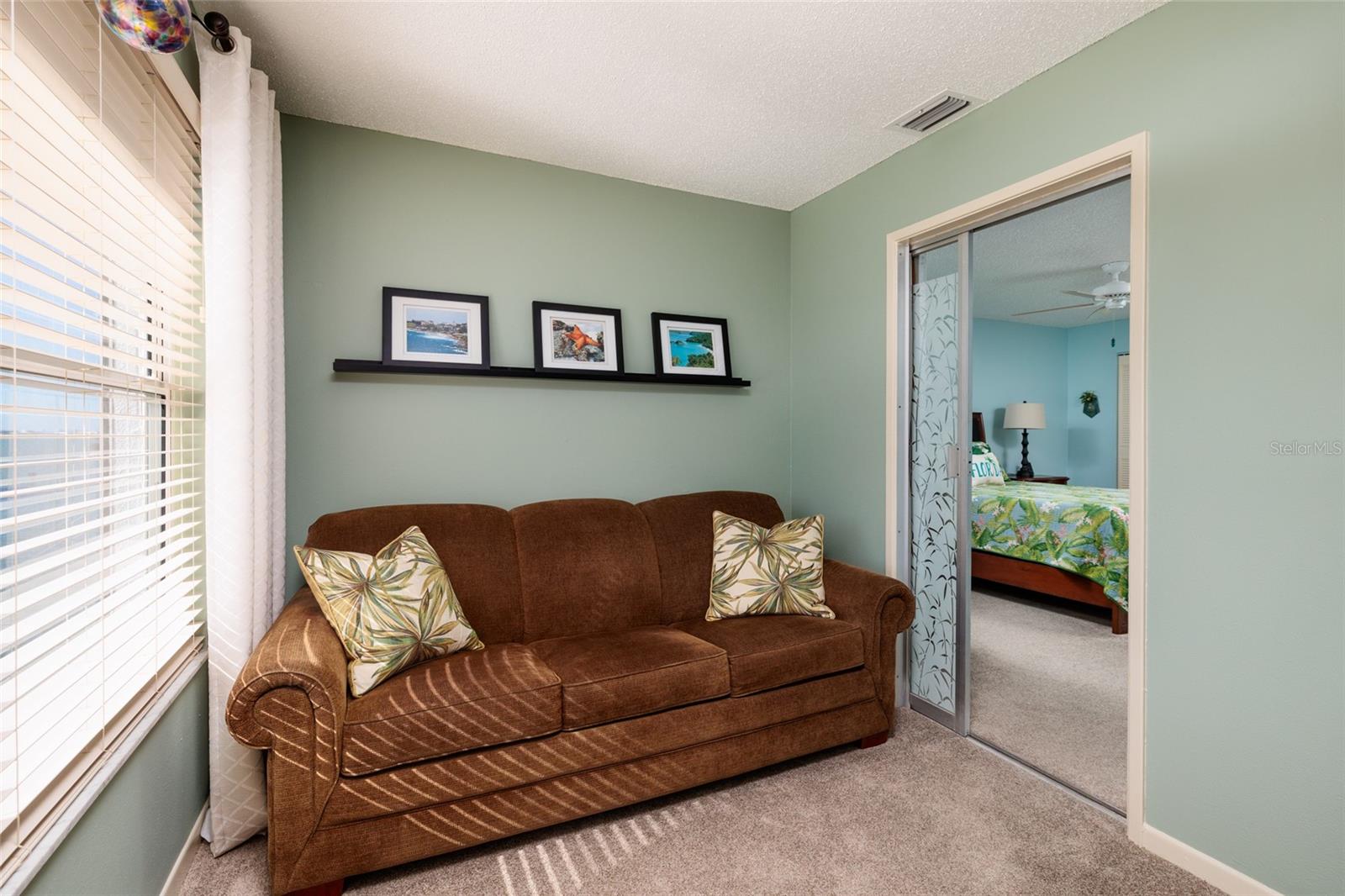 Florida room w/Sleeper sofa & slider to primary bedroom.