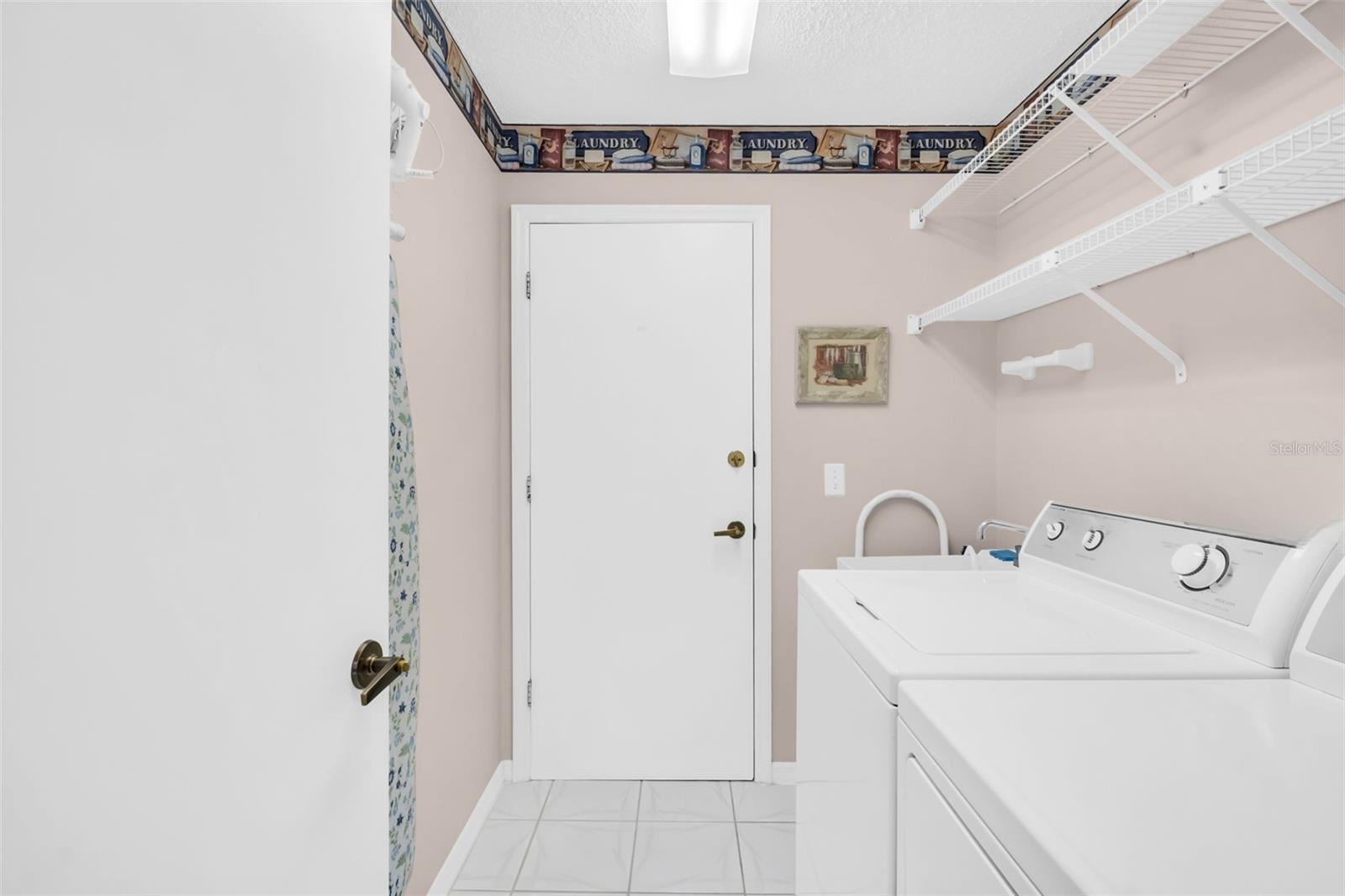 Large laundry room with utiity sink perfectly tucked between the garage & kitchen~