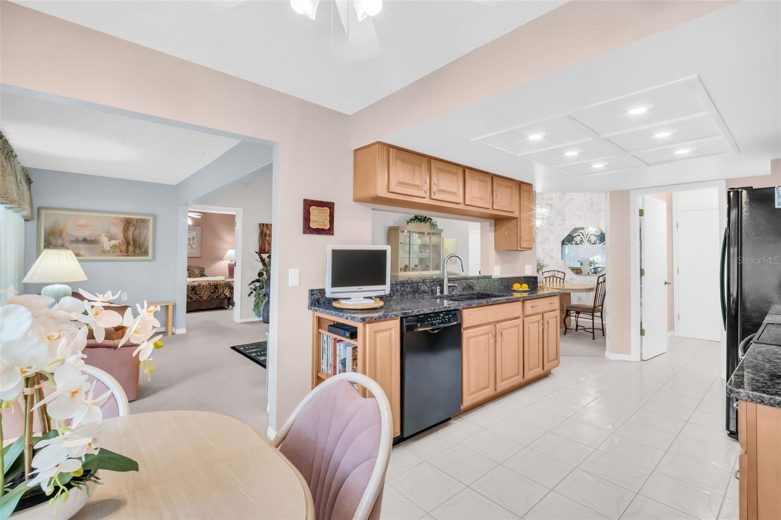 Updated kitchen showcasing new granite countertops, solid wood cabinetry and sleek black applicances~