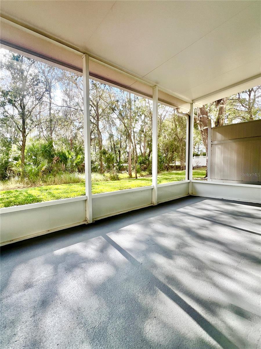 The screened-in back porch is covered and has a beautiful view of conservation.  The 12" kick plate protects the lower part of the screen, and the floor was painted in Oct 2025.  Keep your eyes open for bunnies!