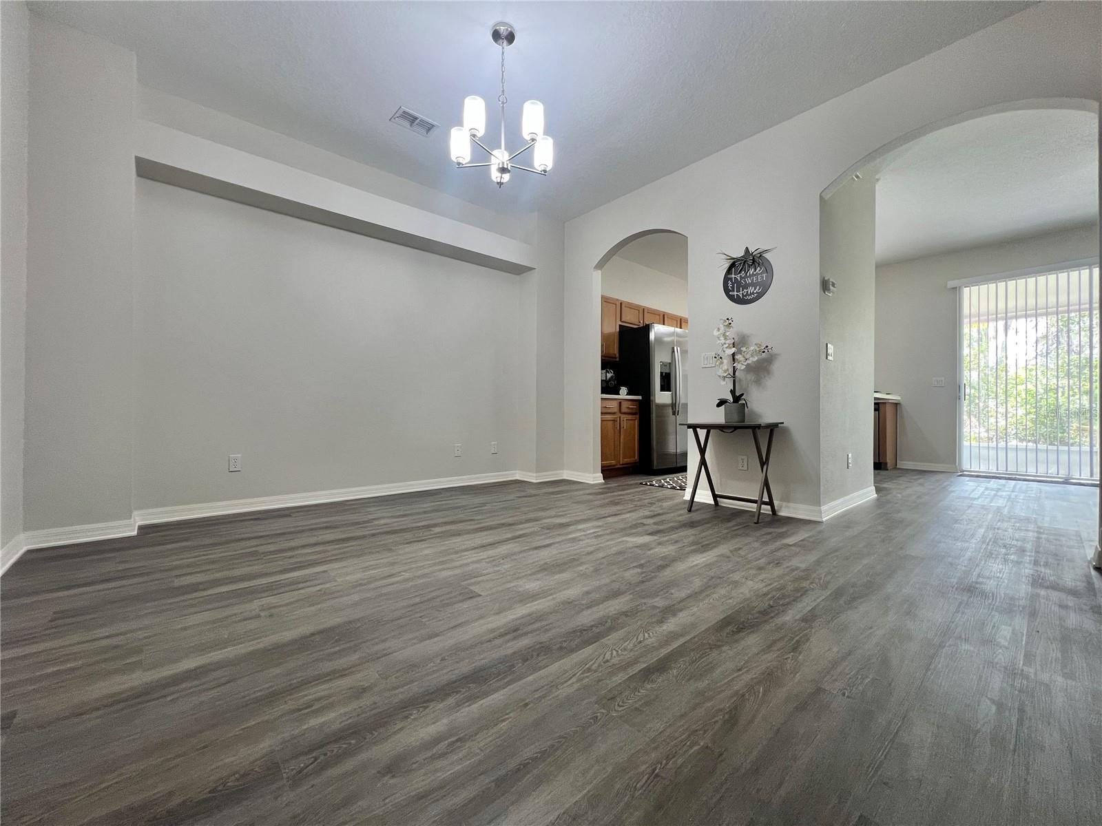 The dining room has a brand new updated lighting fixture.