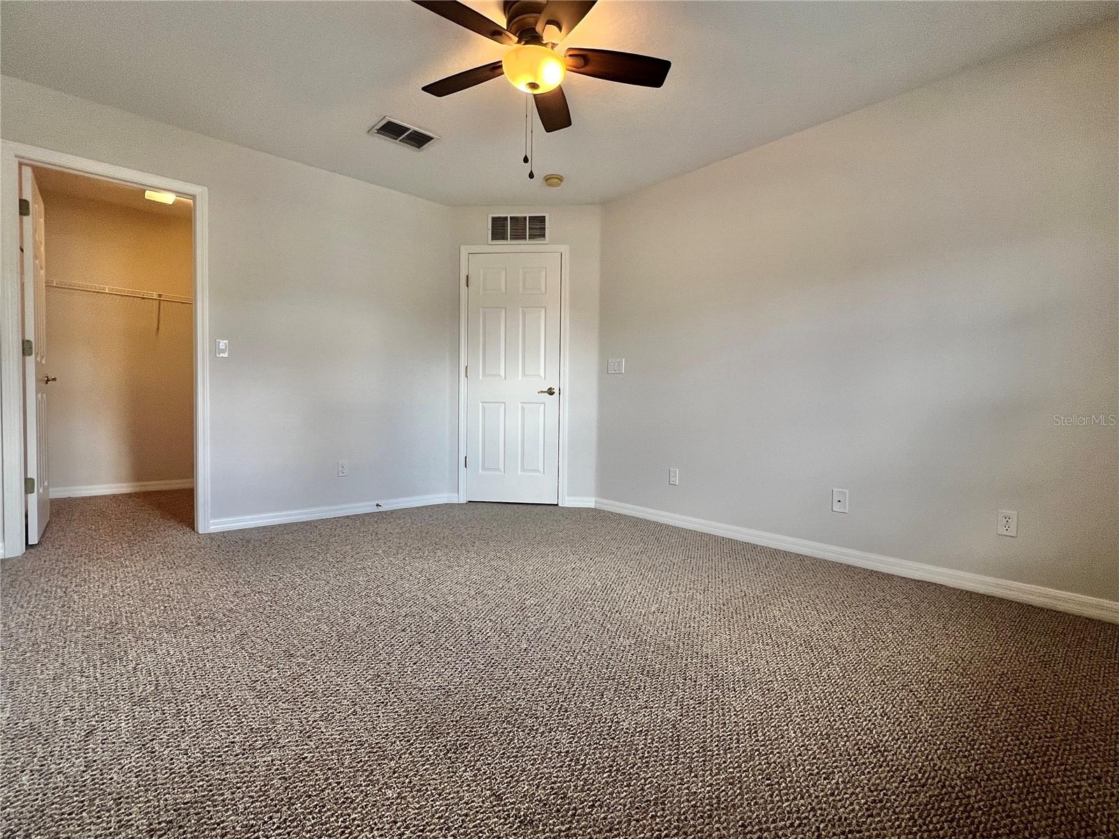 The secondary bedrooms are sizeable and have walk-in closets and lighted ceiling fans.