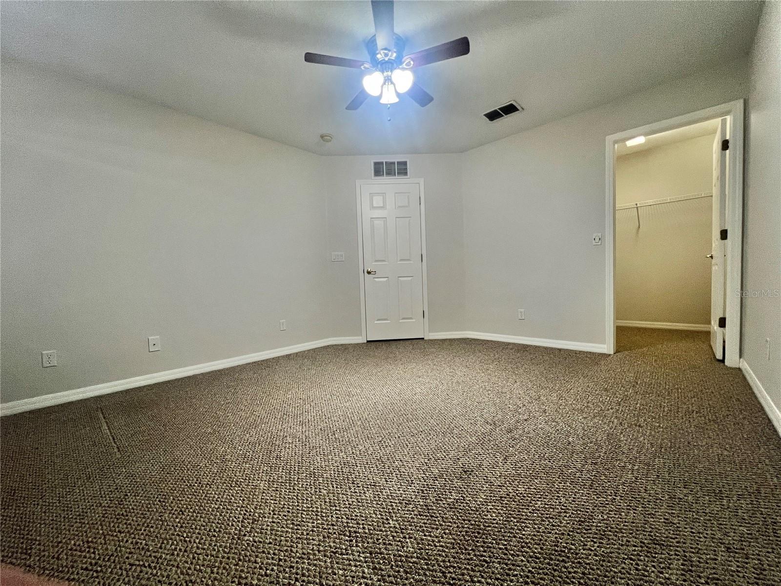 The secondary bedrooms are sizeable and have walk-in closets and lighted ceiling fans.