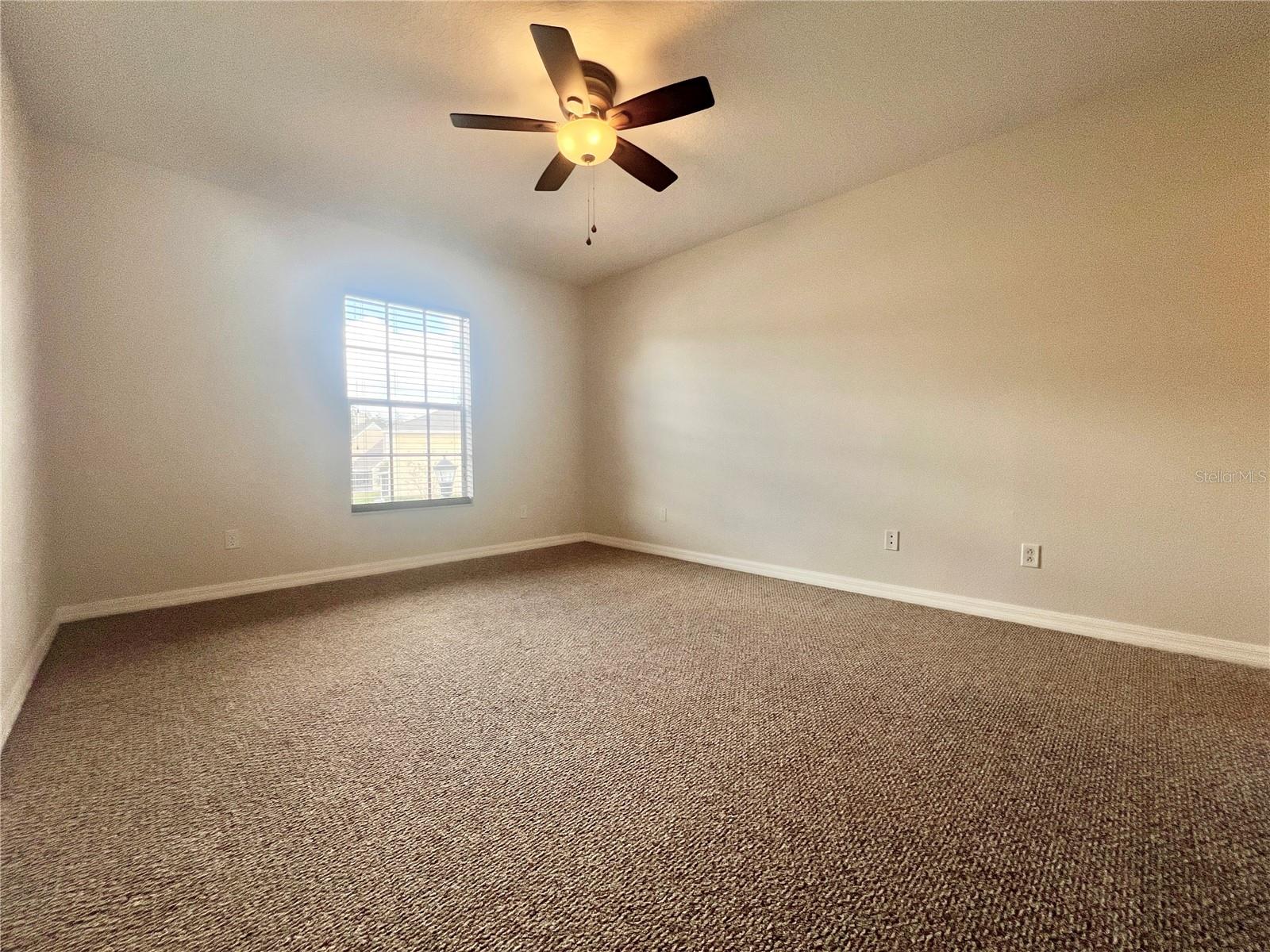The secondary bedrooms are sizeable and have walk-in closets and lighted ceiling fans.