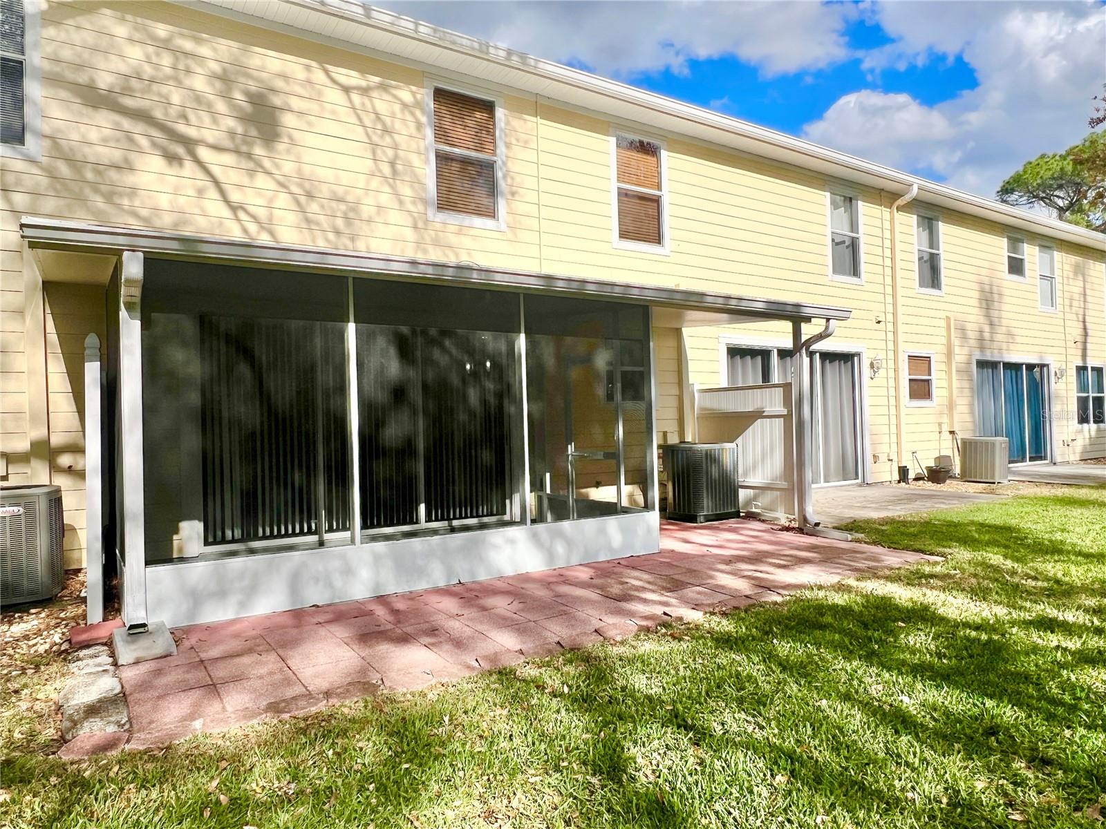 There's a brick-pavered patio outside the screened-in area, a great lounging space, a grilling area, or a long stretch for cornhole competition!!