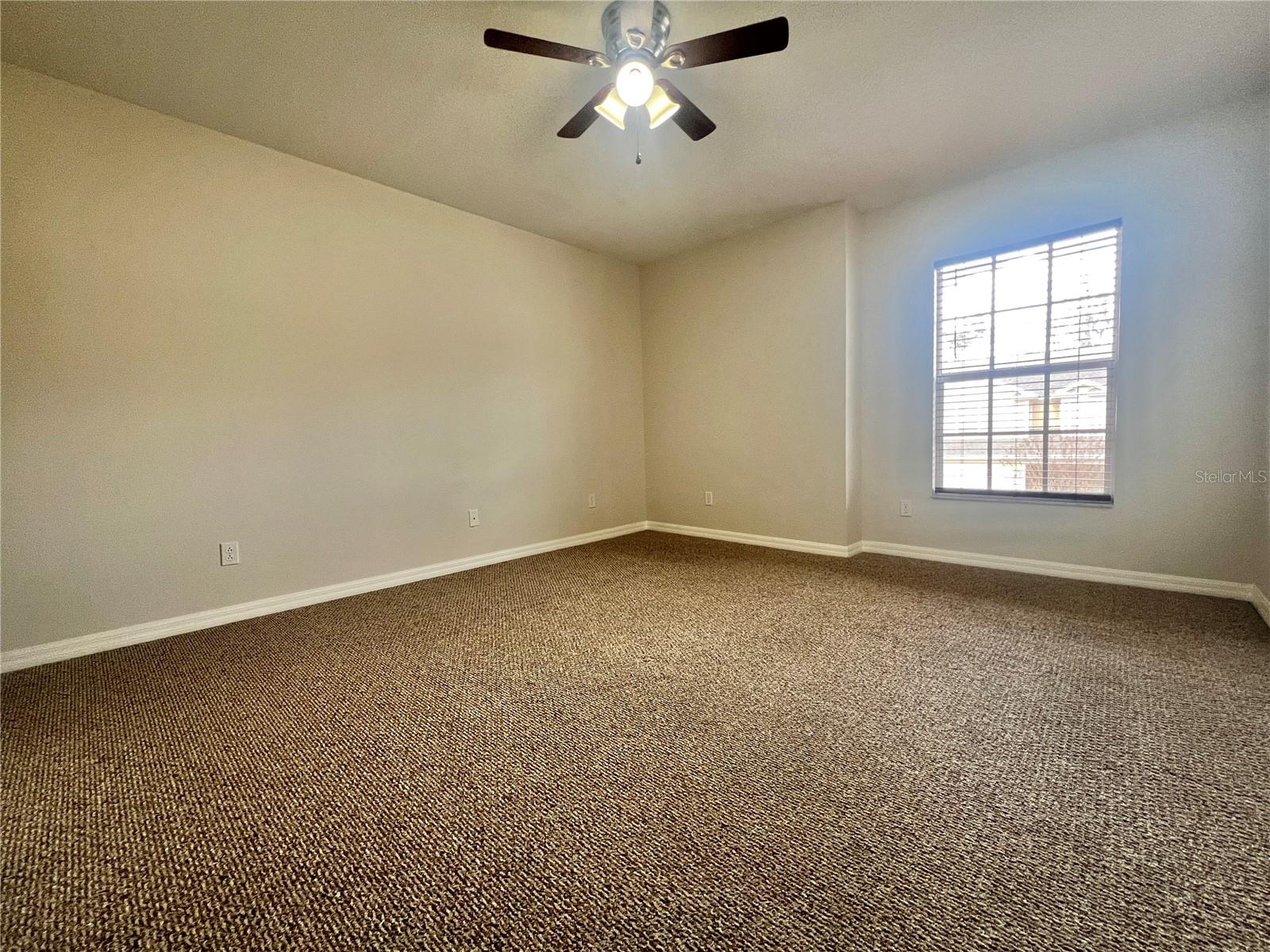 The secondary bedrooms are sizeable and have walk-in closets and lighted ceiling fans.